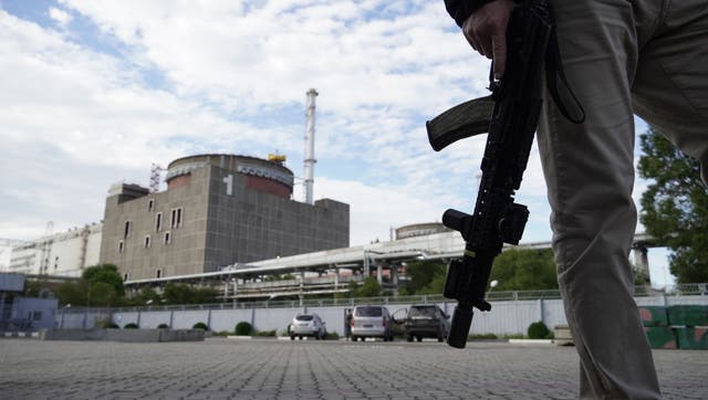 <p>A security person standing in front of the Zaporizhzhia Nuclear Power Plant in Enerhodar (Energodar), Zaporizhzhia oblast in Ukraine</p>