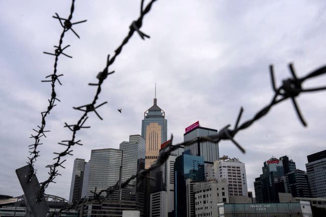 <p>File image:  A Hong Kong cityscape behind a barbed wire.  </p>