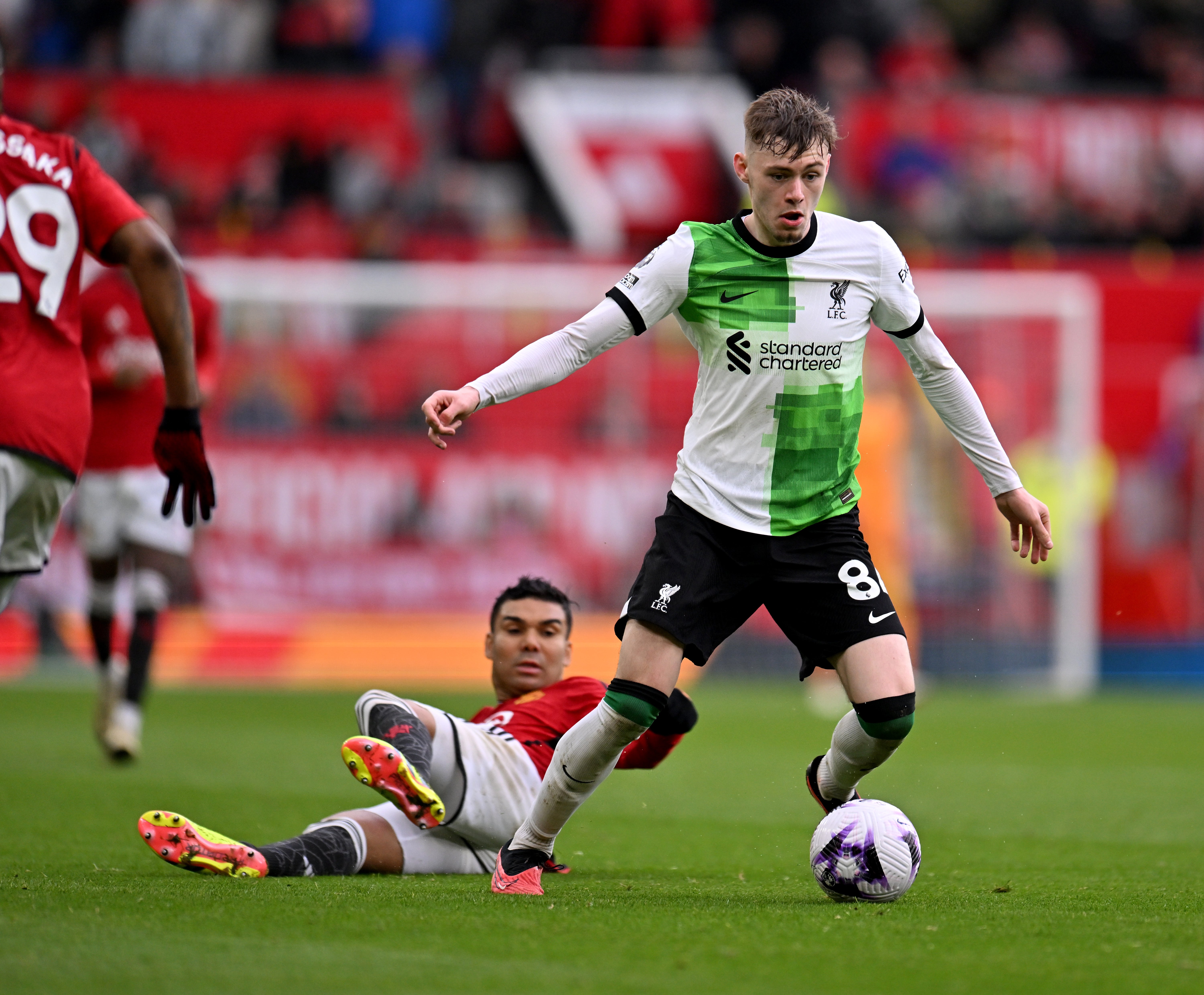 Conor Bradley of Liverpool escapes from Casemiro