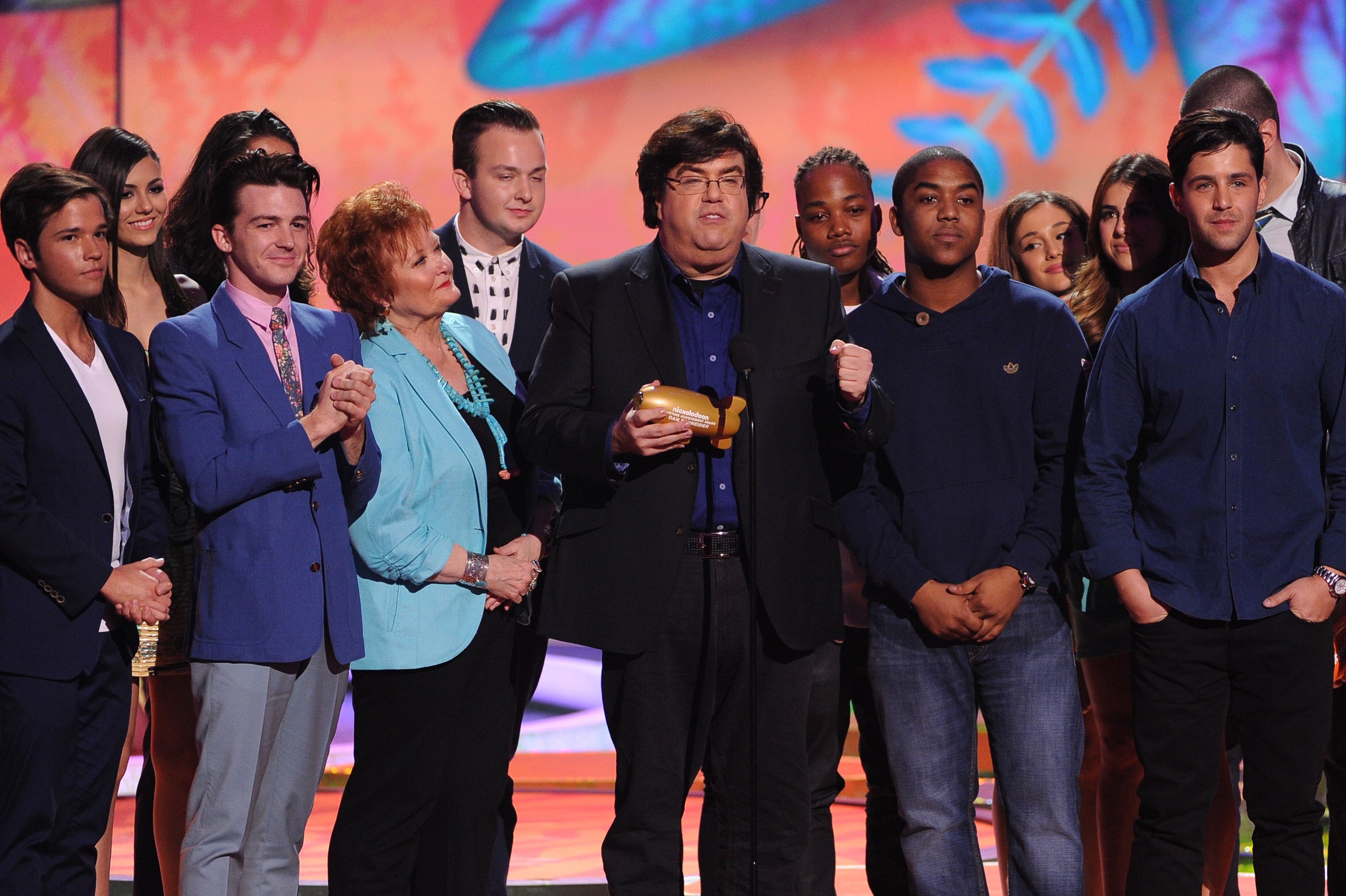 Writer/producer Dan Schneider (C) accepts the Lifetime Achievement Award onstage with actors from his shows during Nickelodeon's 27th Annual Kids' Choice Awards