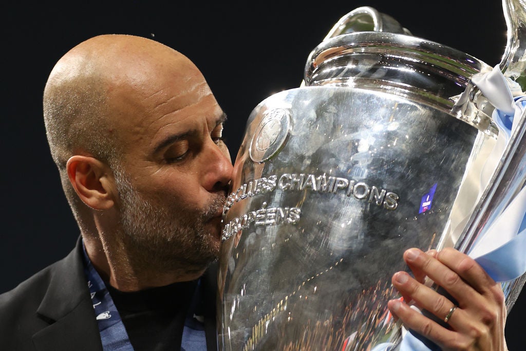 Pep Guardiola kisses the Champions League trophy after victory over Inter in Istanbul in June