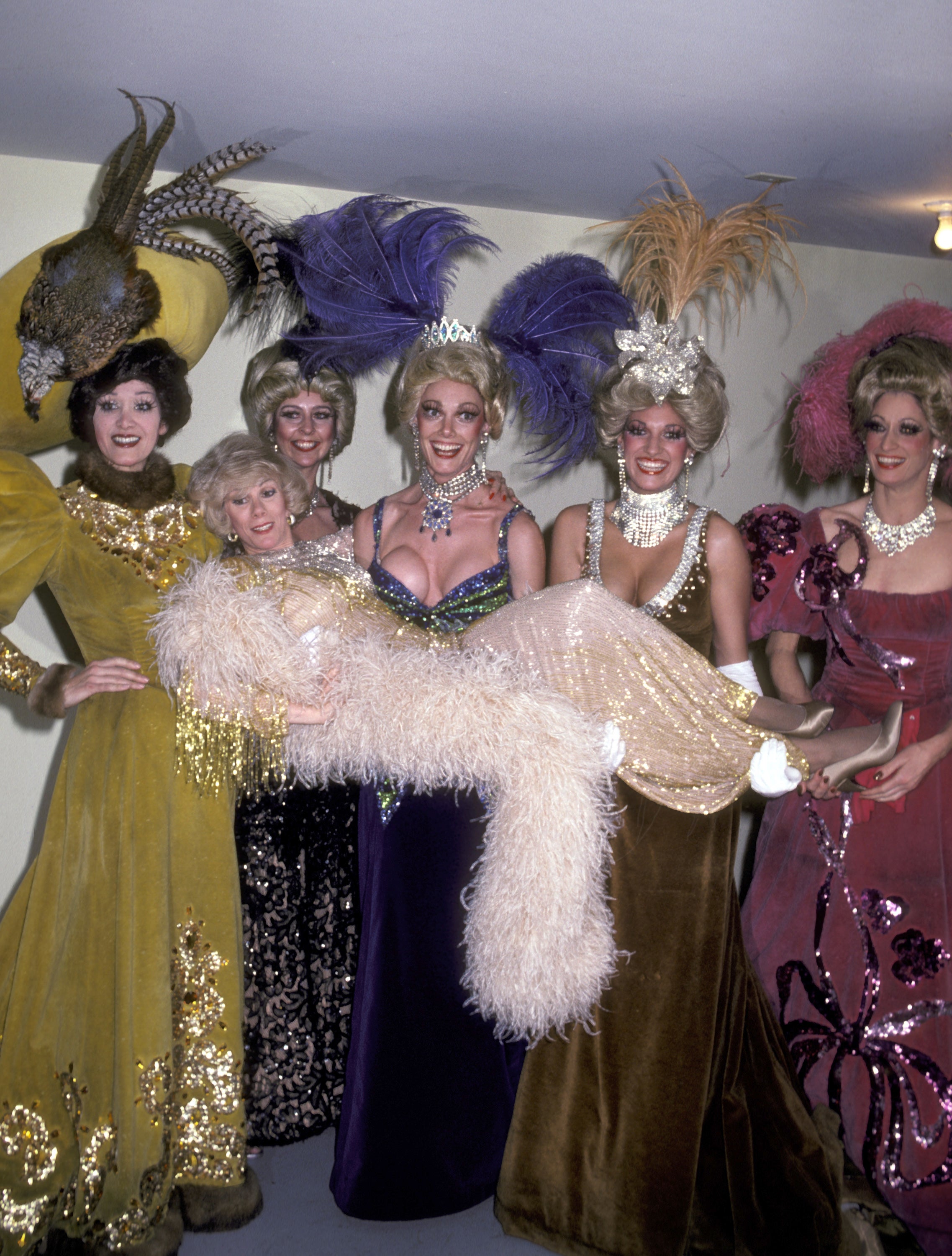 Joan Rivers, one of the many famous faces to grace the Tropicana, poses with Folies Bergere showgirls; singers like Frank Sinatra numbered among other star performers, while the Trop also featured as a Rat Pack hangout