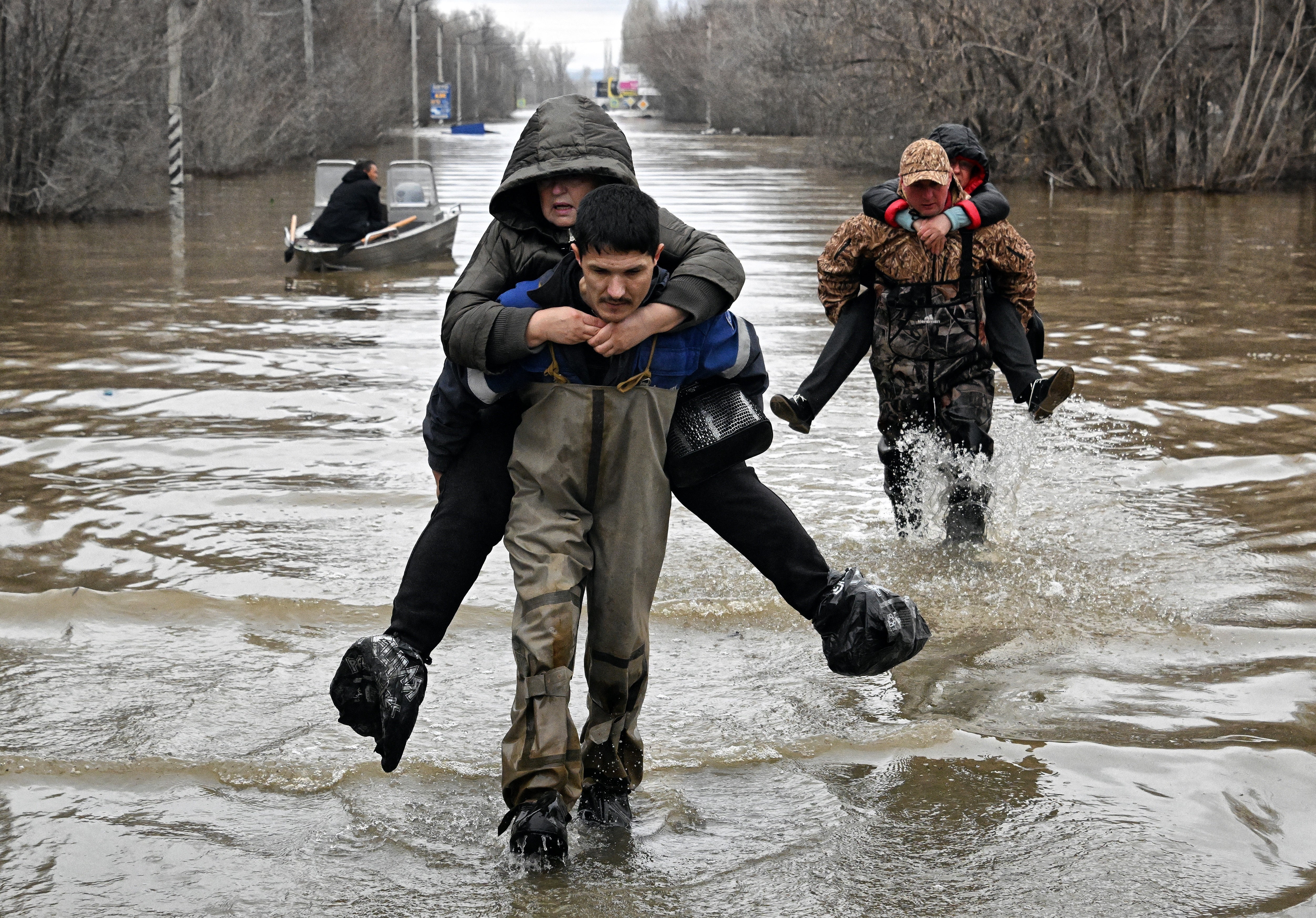 Rescuers evacuate residents from the flooded part of the city of Orsk, in Russia’s Orenburg region