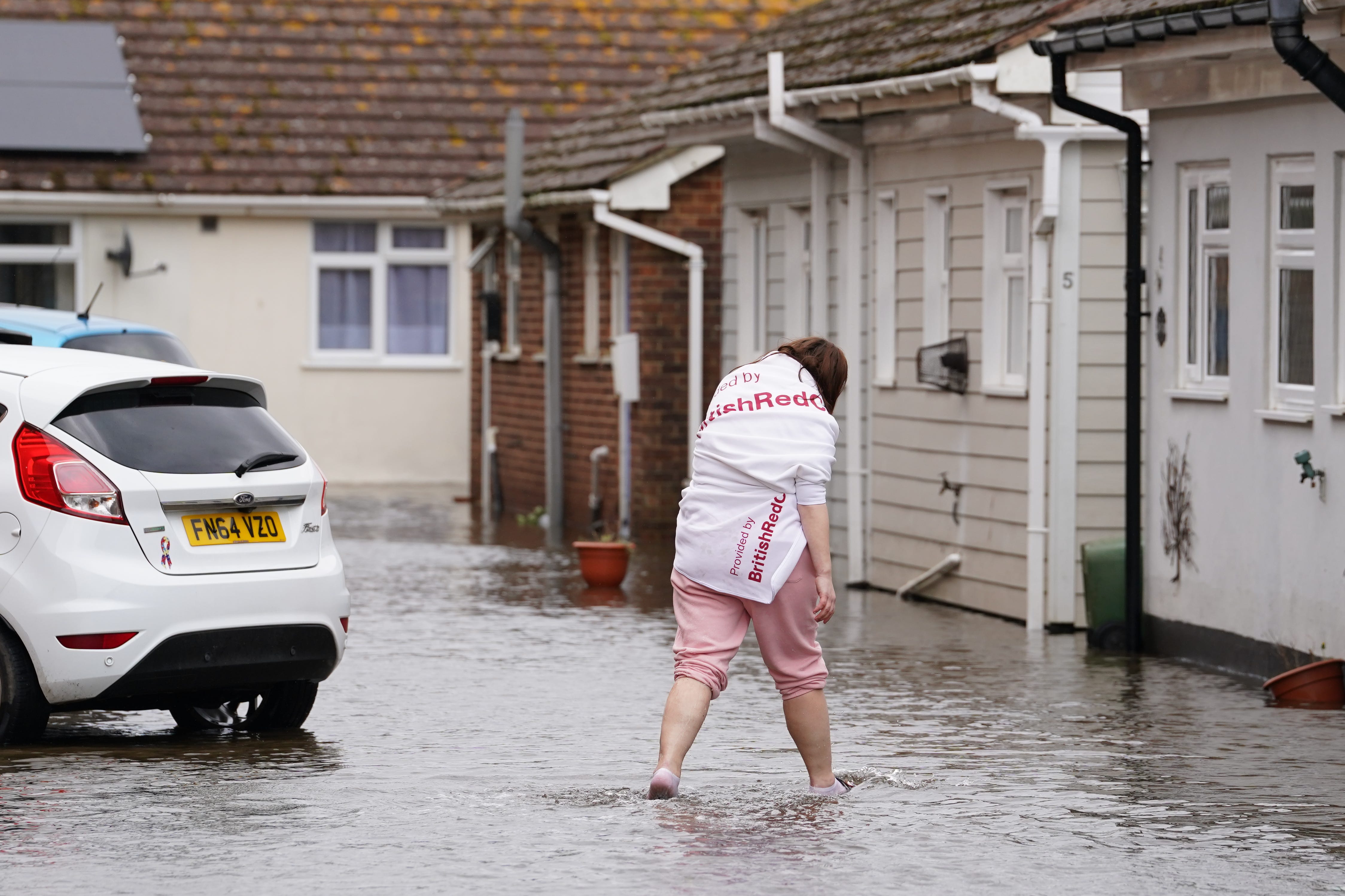 A resident wades through flood water in Littlehampton (Gareth Fuller/PA)