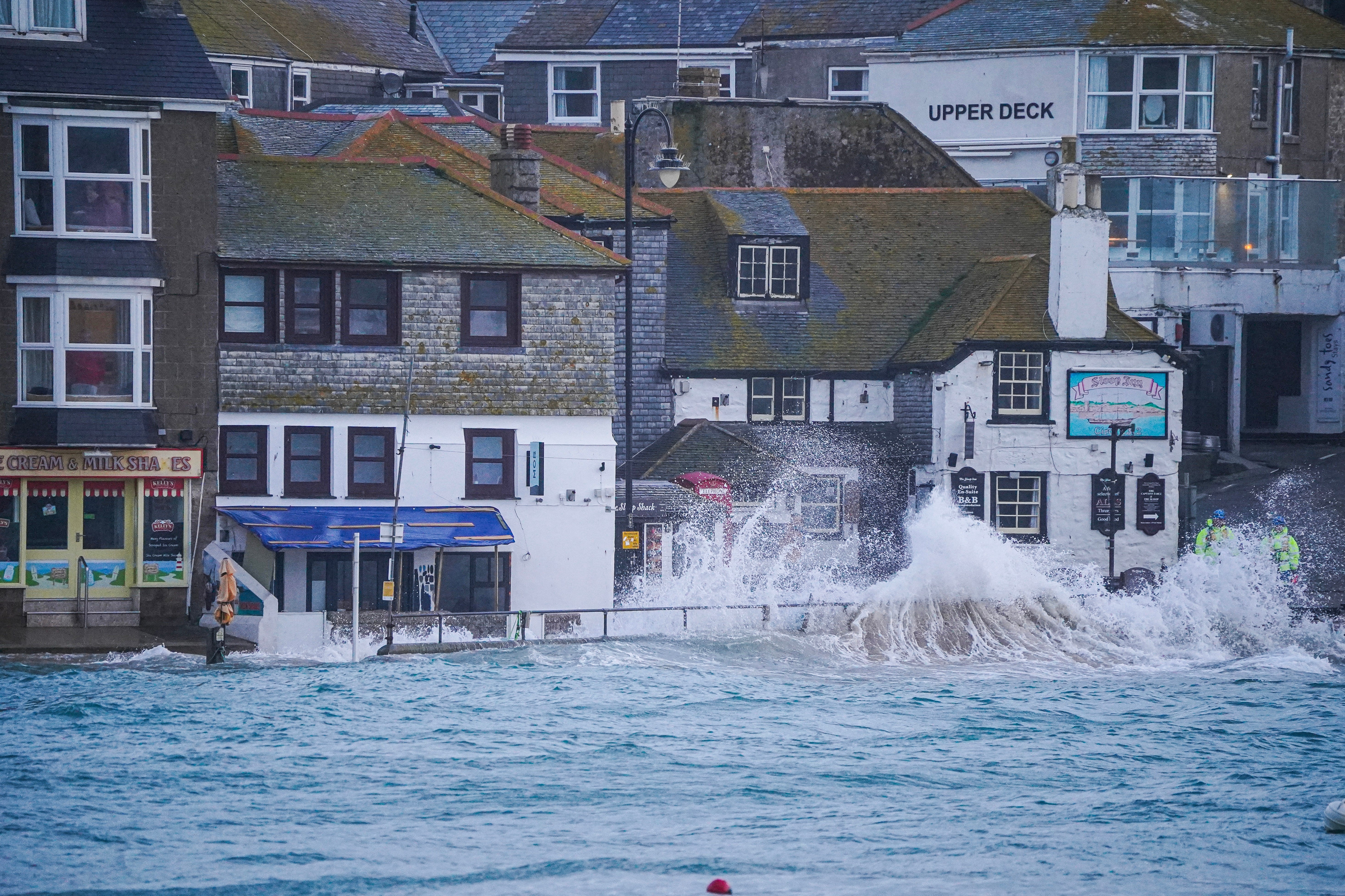 Waves strike the harbourside in St Ives, Cornwall