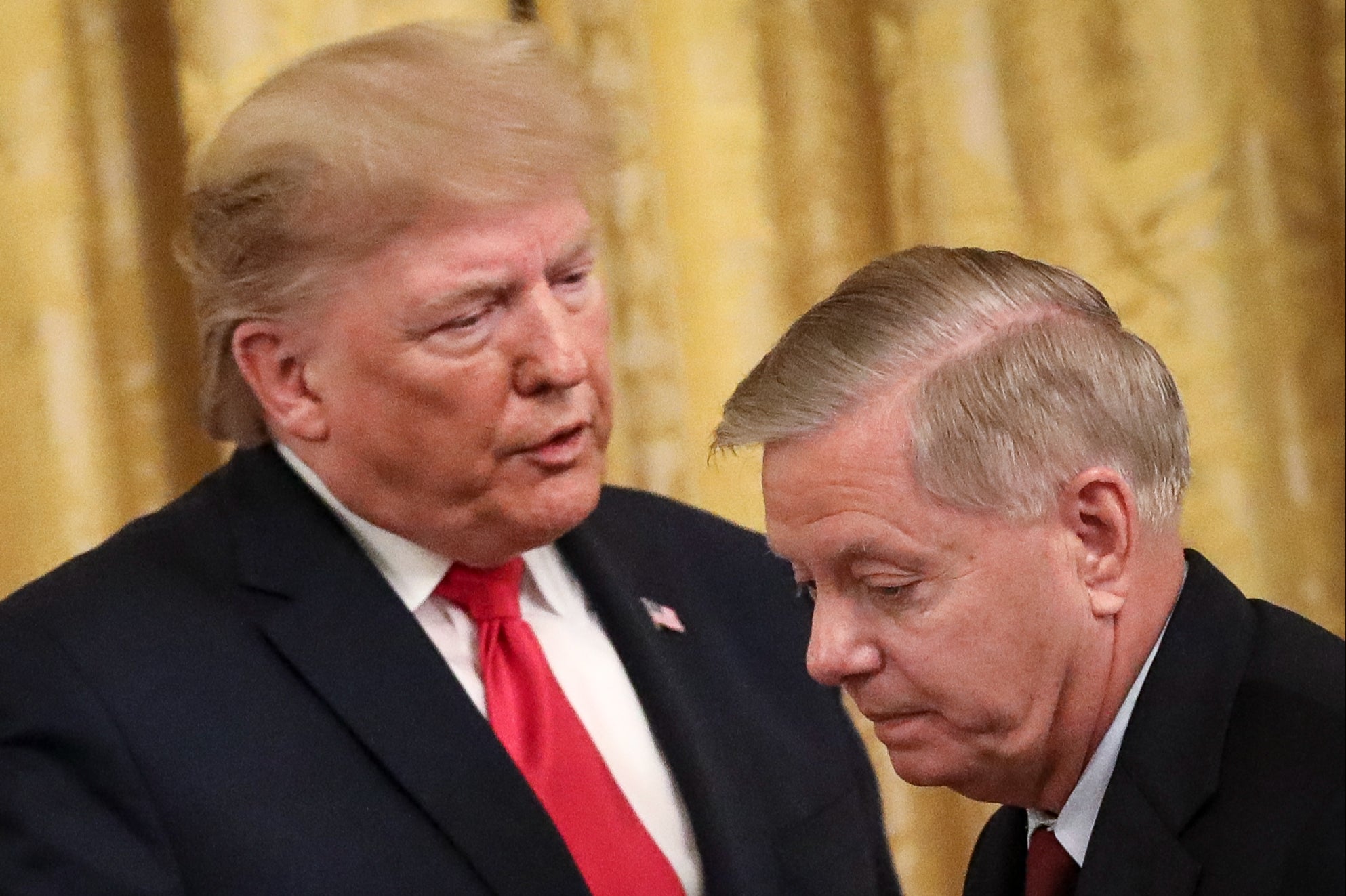 Woodward’s book relays a series of alleged conversations between Senator Lindsey Graham and Donald Trump (pictured together in 2019)