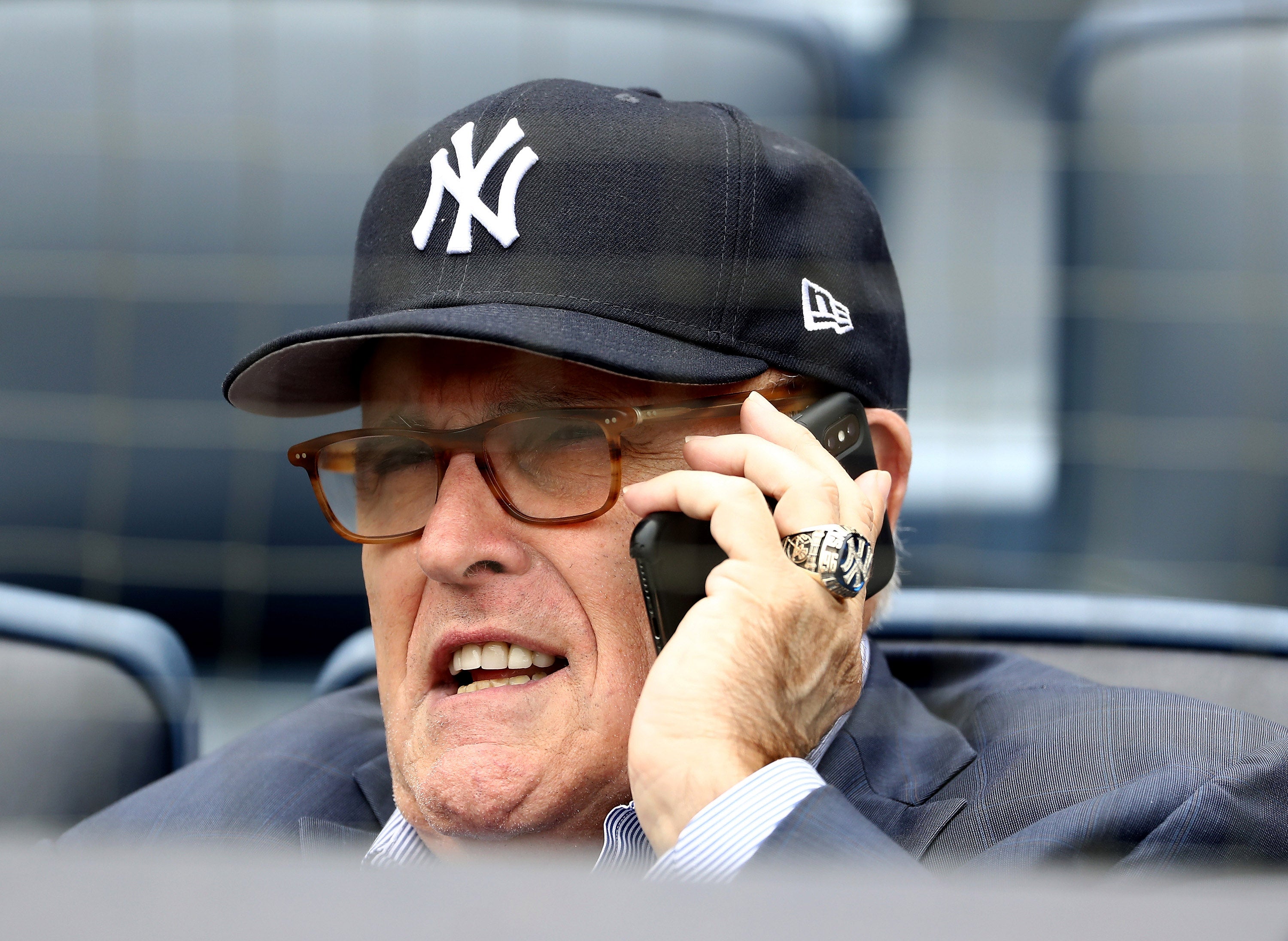 Former mayor Rudy Giuliani boasting Yankees gear at a baseball game in May 2018