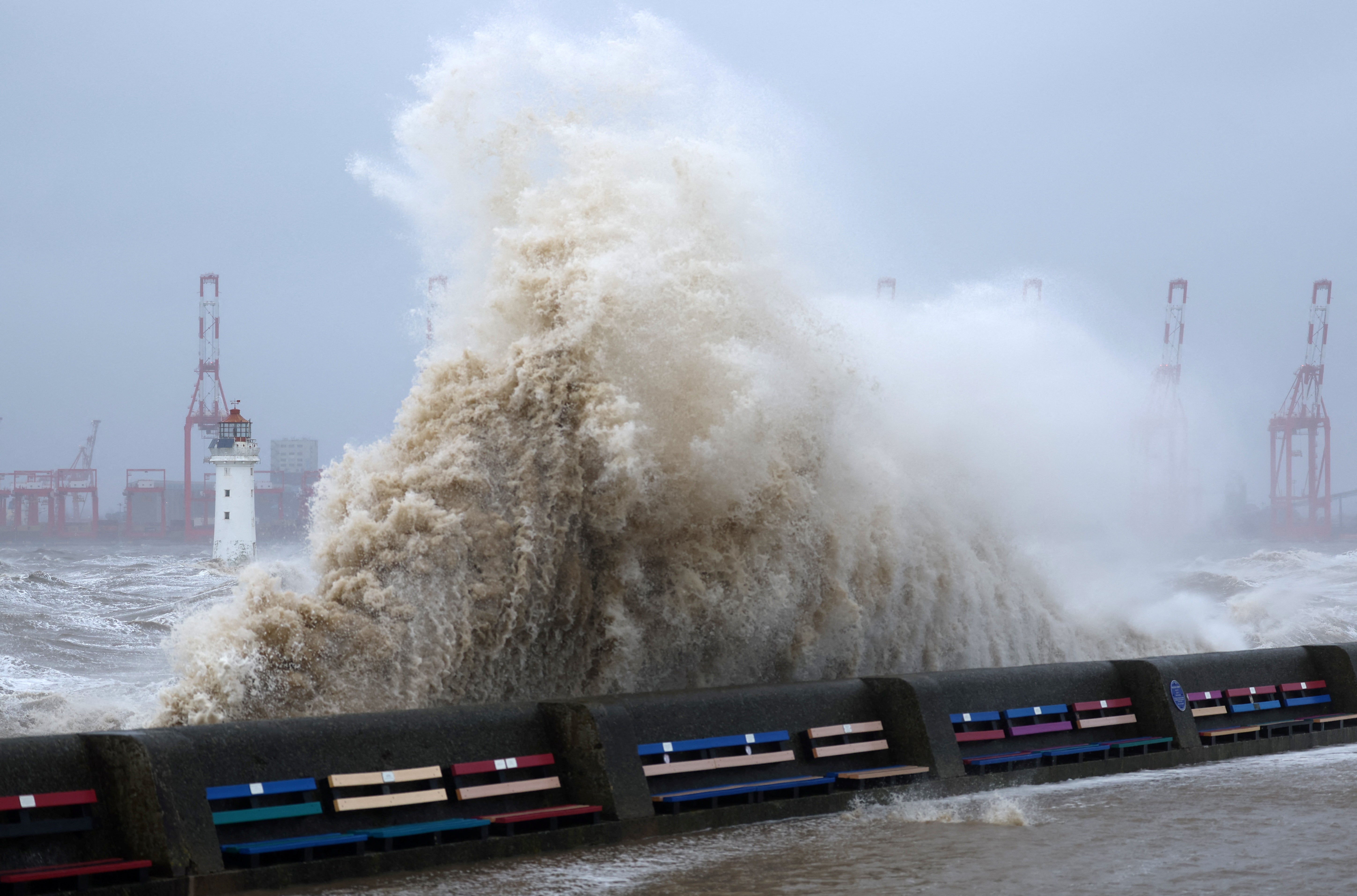 Waves crash over the sea wall during a storm in Brighton