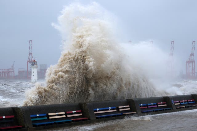 <p>Waves crash over the sea wall in Brighton </p>