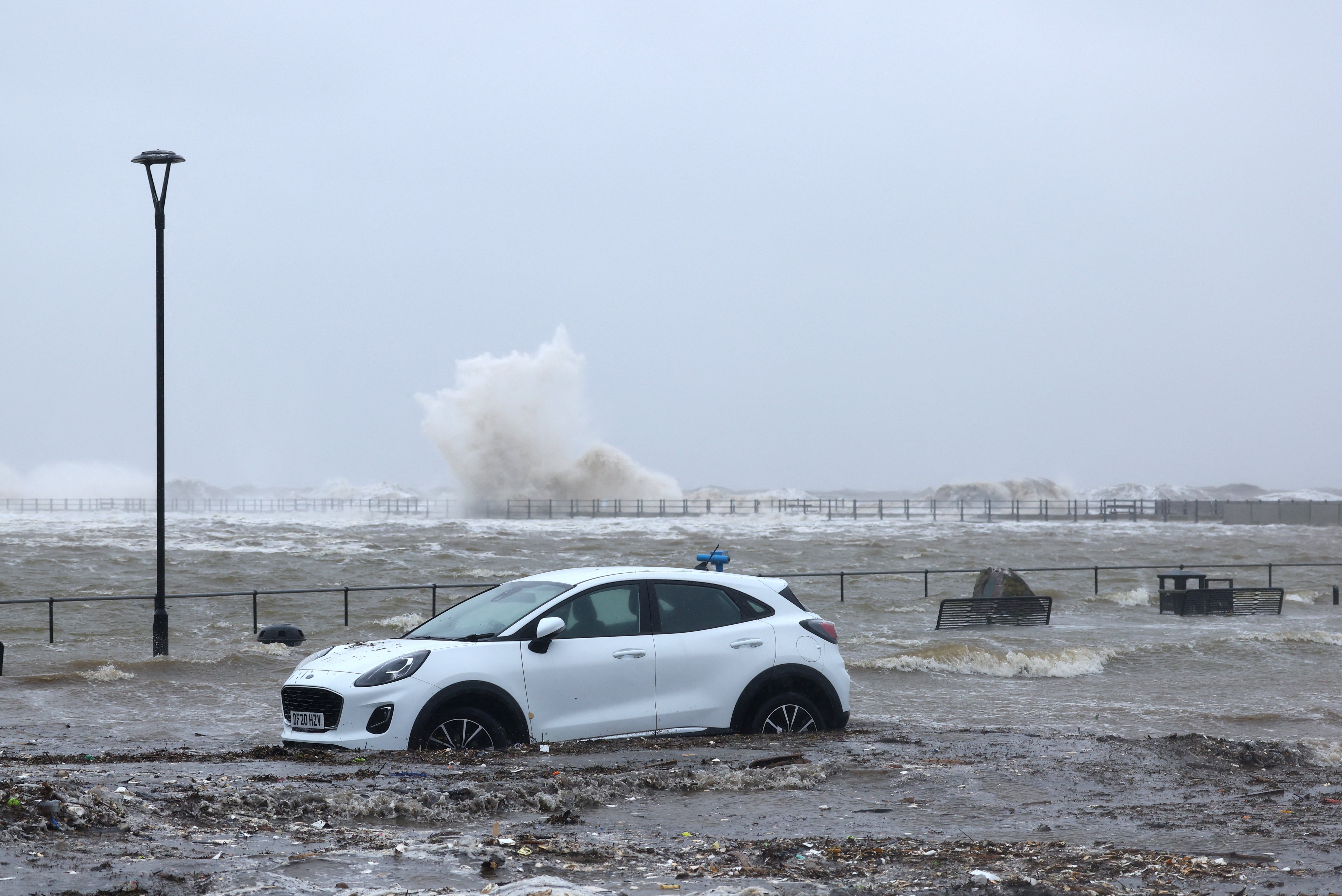 A car drives through floodwaters this week in Brighton