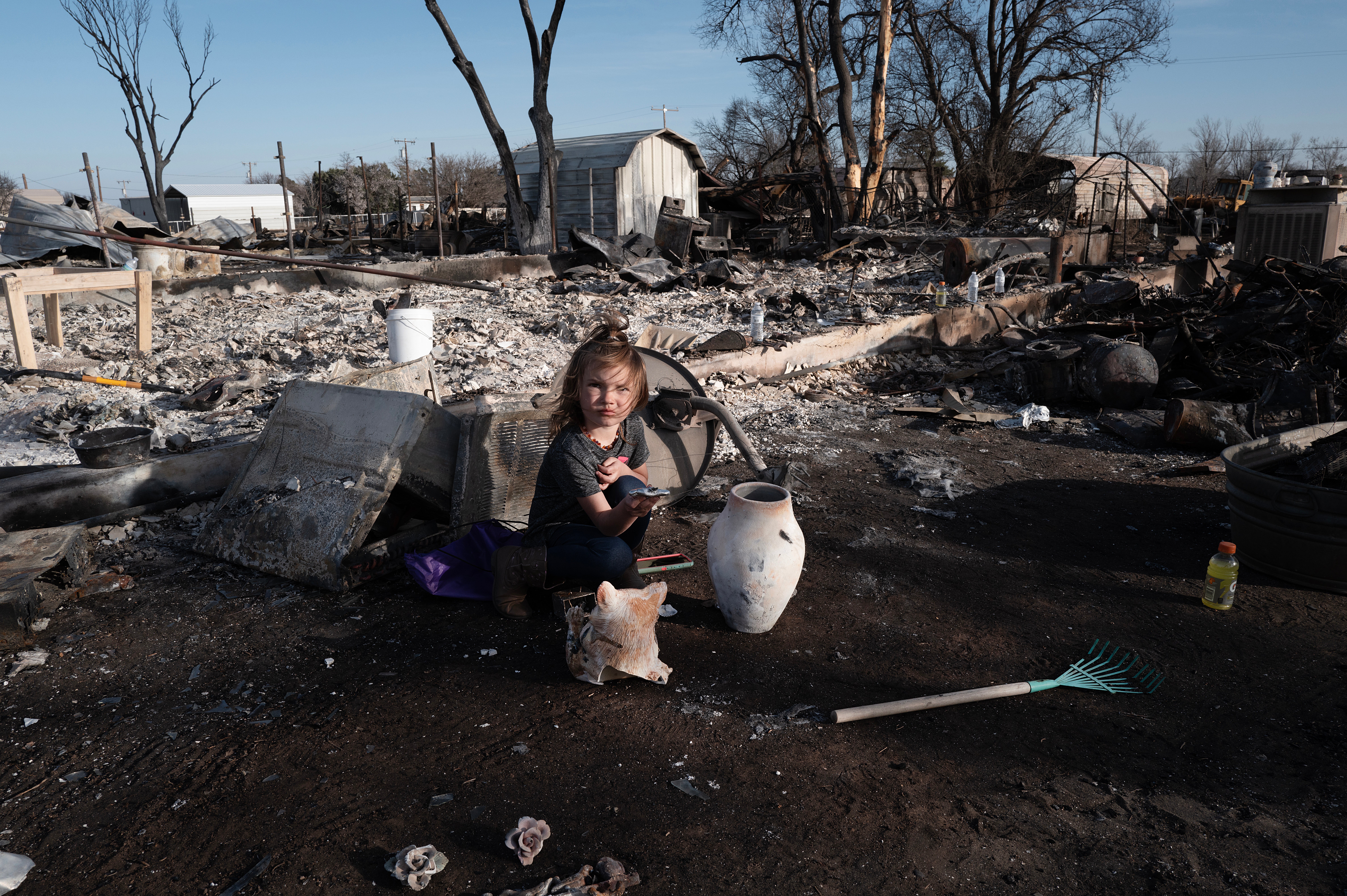 Aurora Champion does her part as her parents help a friend whose home was destroyed by the Smokehouse Creek fire on 3rd March 2024 in Stinnett, Texas