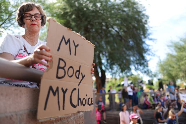 <p>A protestor holds a sign reading ‘My Body My Choice’ at a Women’s March rally  outside the State Capitol on October 8, 2022 in Phoenix, Arizona.</p>