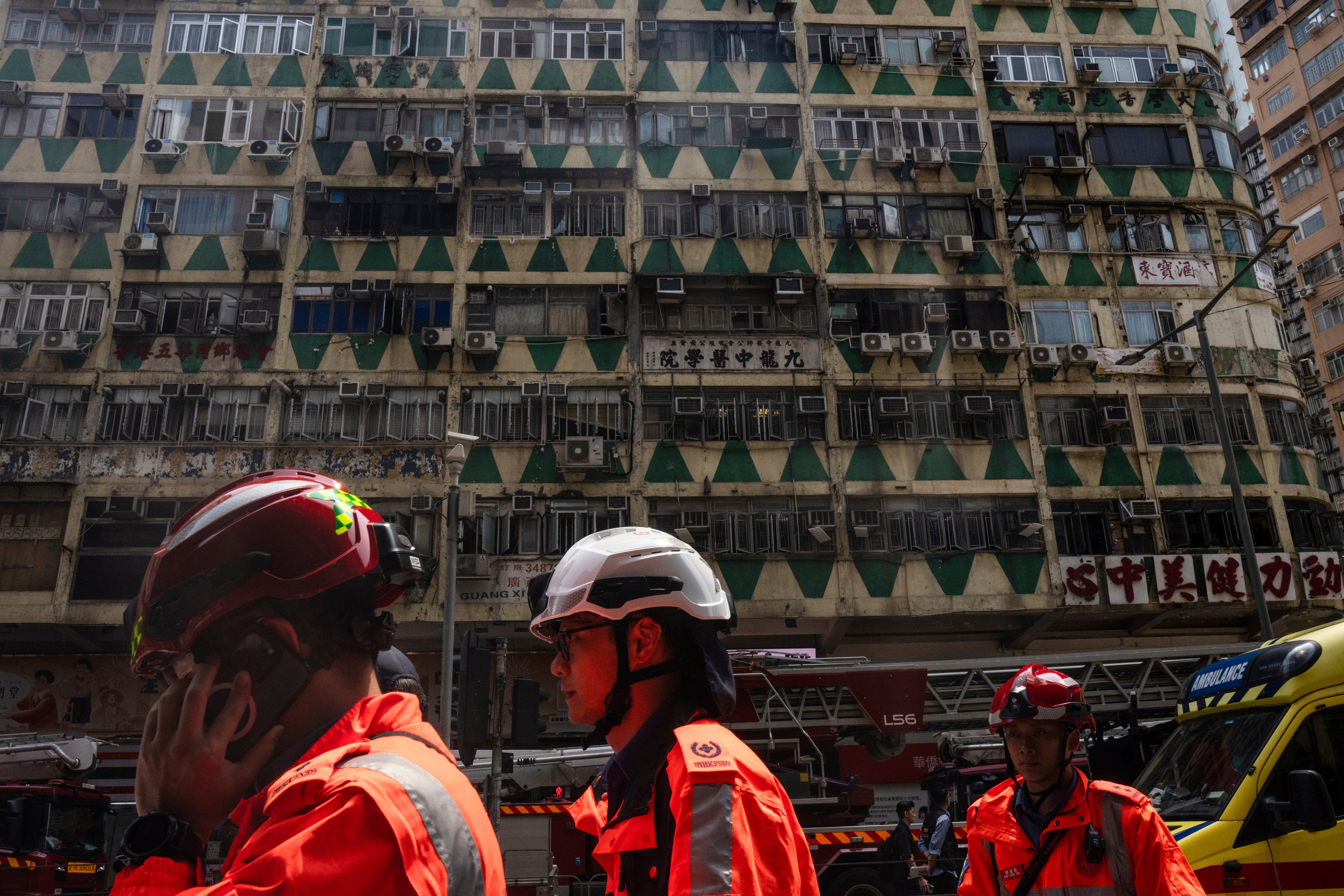 Firefighters walk past a building called New Lucky House where a fire started in Hong Kong, Wednesday, 10 April 2024