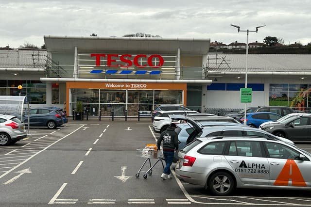Tesco has reported higher sales and profits for the past year (Peter Byrne/PA)