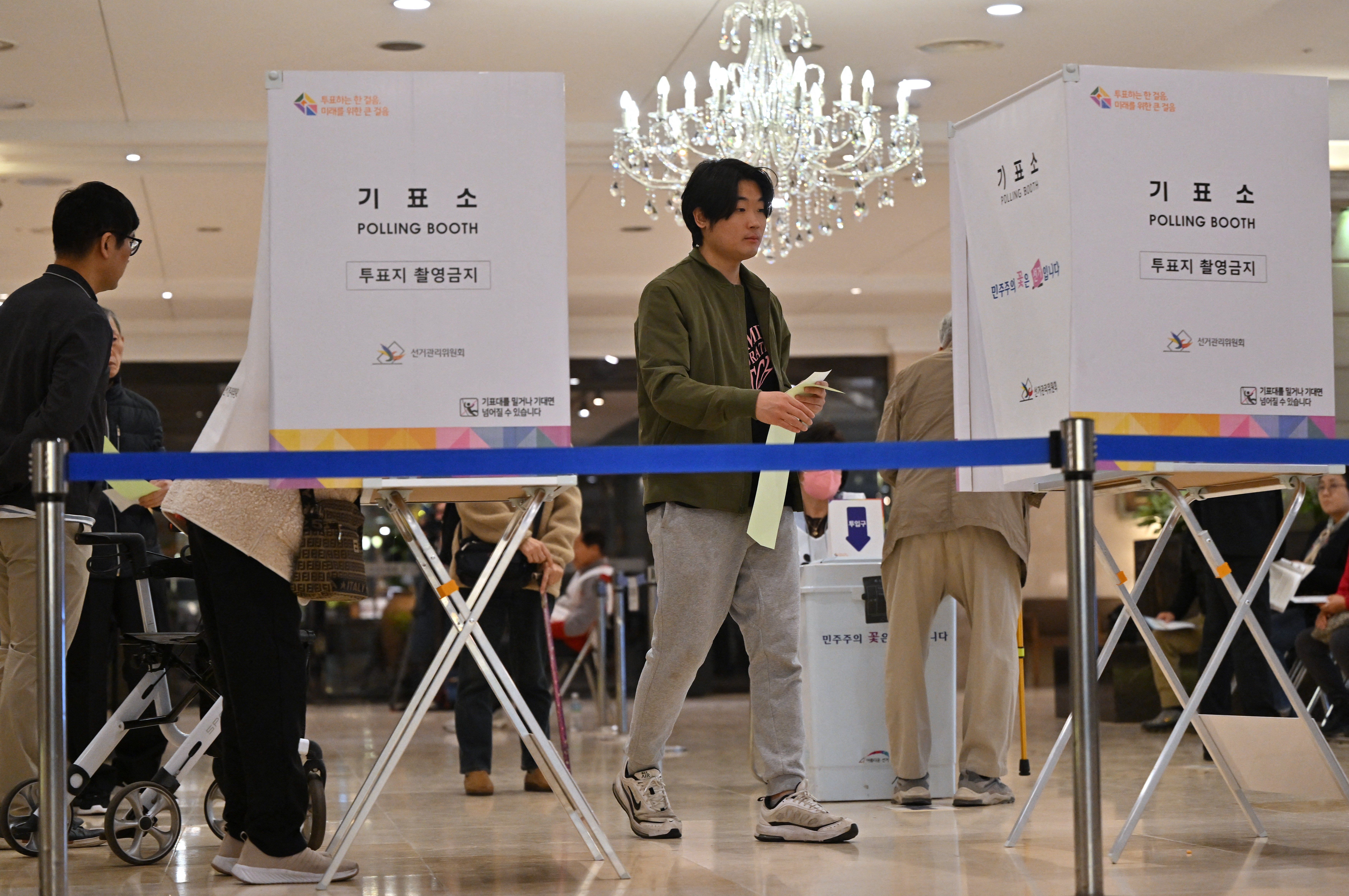 South Koreans cast their ballots during the parliamentary elections at a polling station located in a wedding hall in Seoul on 10 April 2024