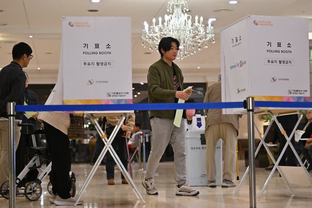 <p>South Koreans cast their ballots during the parliamentary elections at a polling station located in a wedding hall in Seoul on 10 April 2024</p>