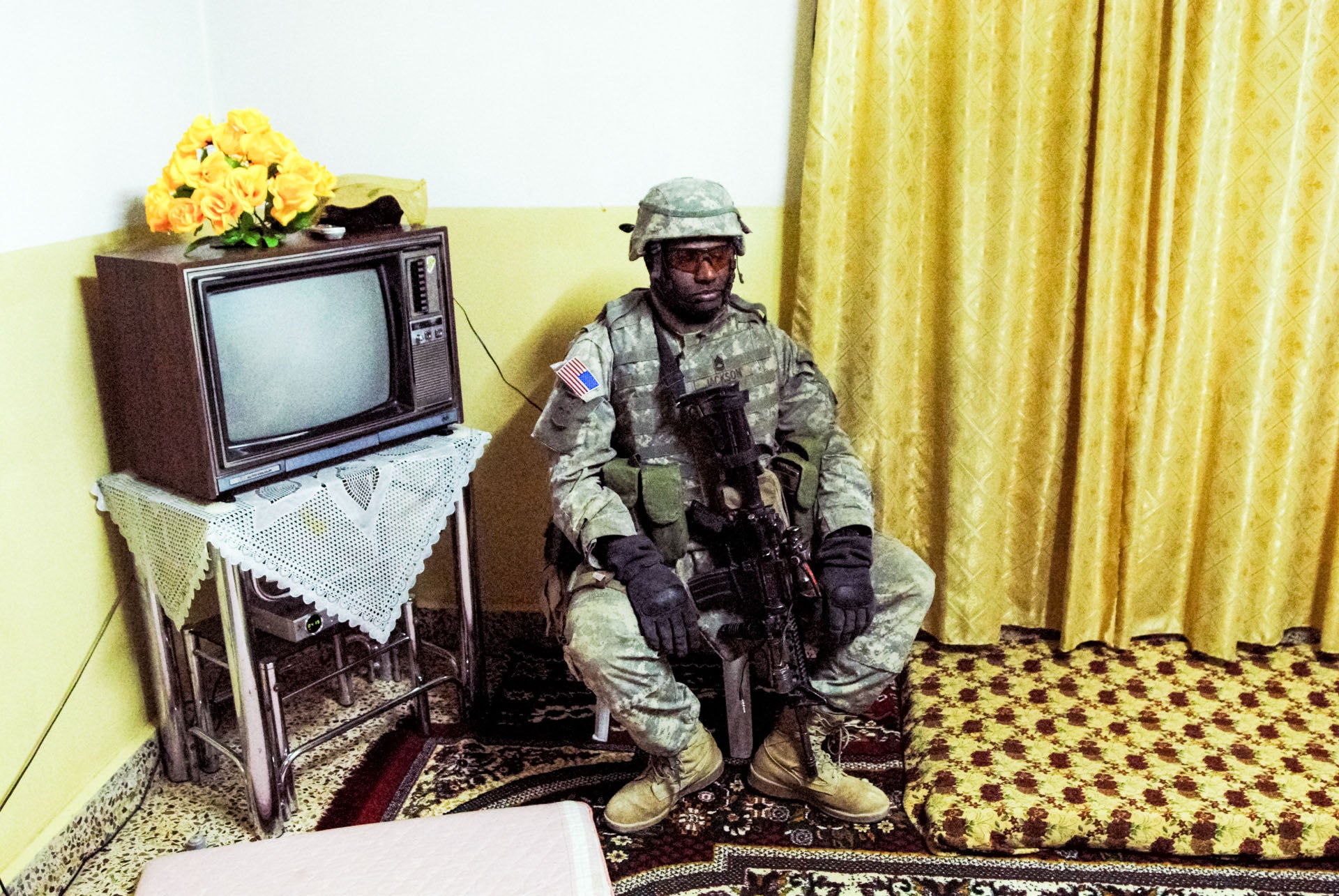 An American soldier rests during a night raid in Rawa, Iraq in 2006