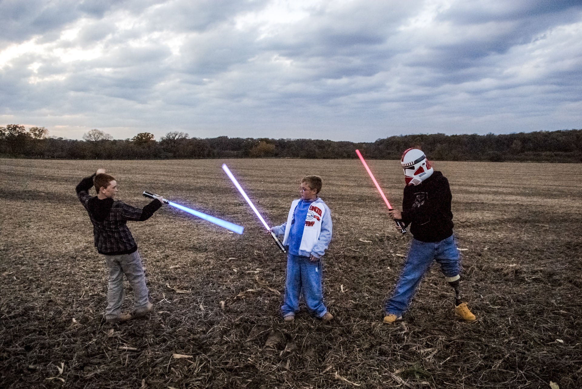 Raymond Hubbard, who lost his leg to a rocket attack in Iraq on 4 July 2006, plays Star Wars with his sons Brady and Riley in Darien, Wisconsin in 2007.