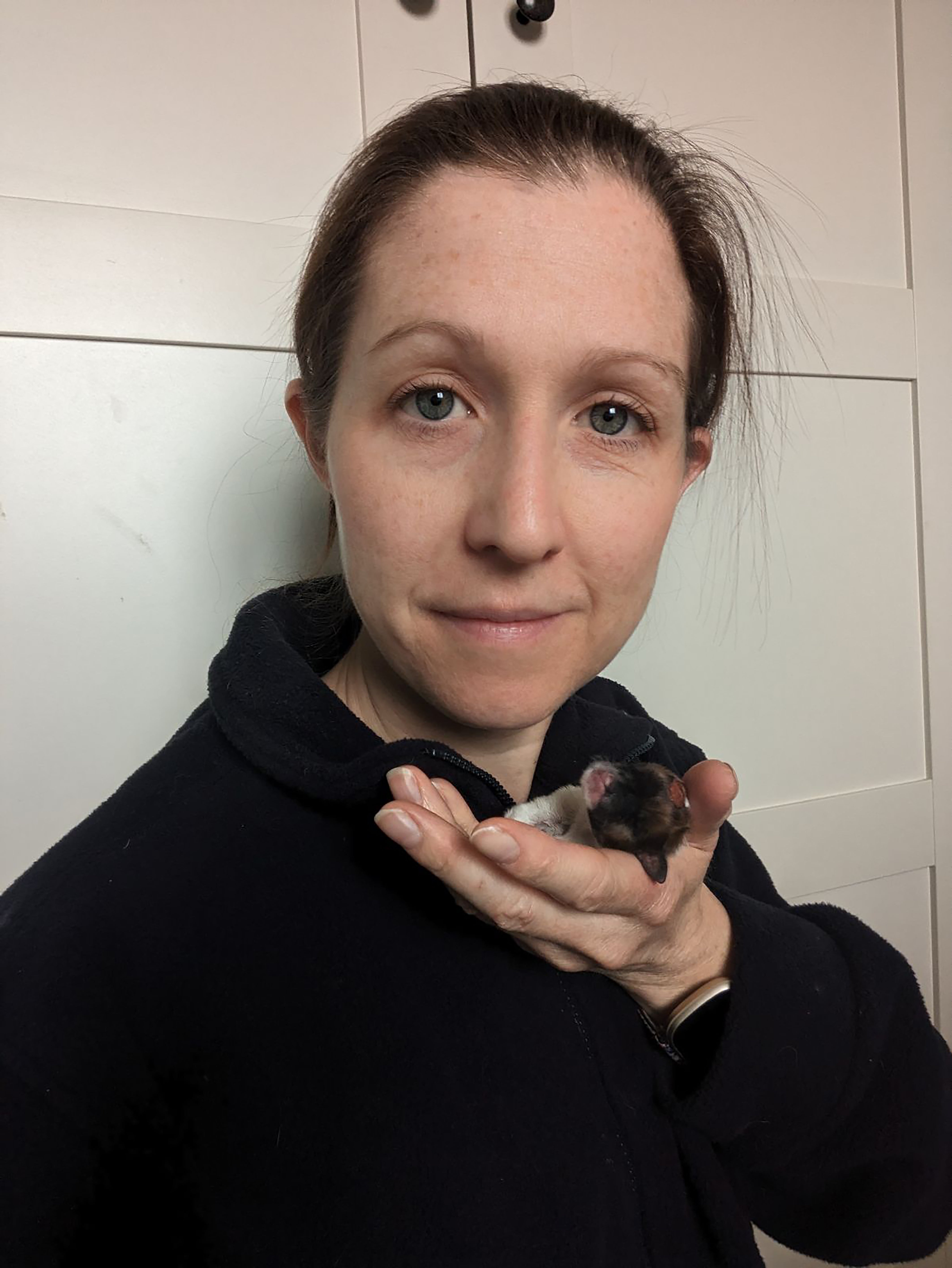 RSPCA staff member Leanna holding a puppy named Puzzle