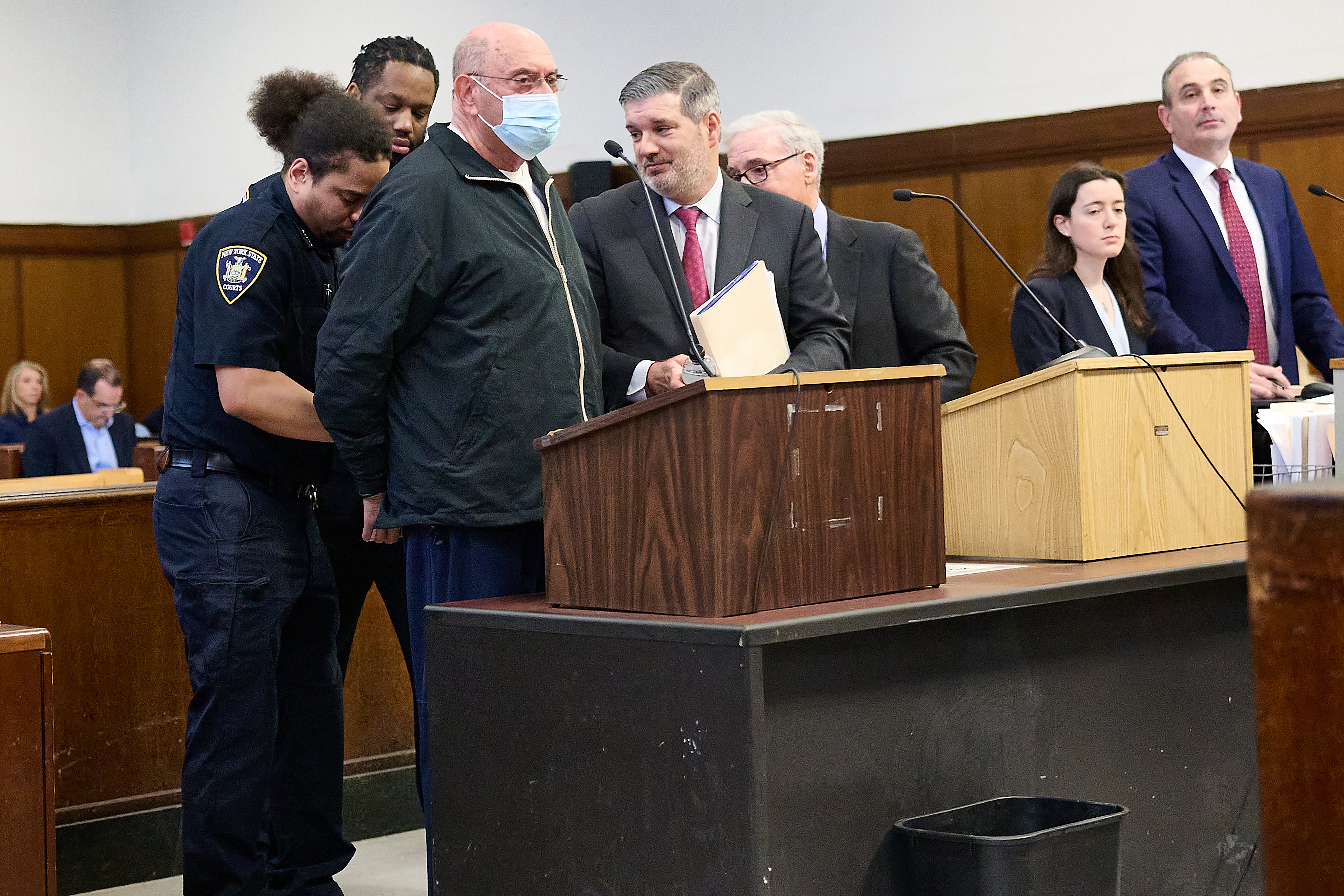 Allen Weisselberg is placed in handcuffs after his sentencing in a Manhattan criminal court on 10 April on perjury charges
