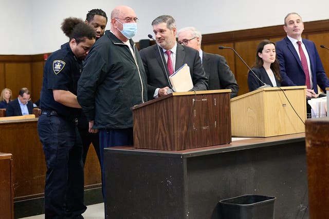 <p>Allen Weisselberg is placed in handcuffs after his sentencing in a Manhattan criminal court on 10 April on perjury charges</p>