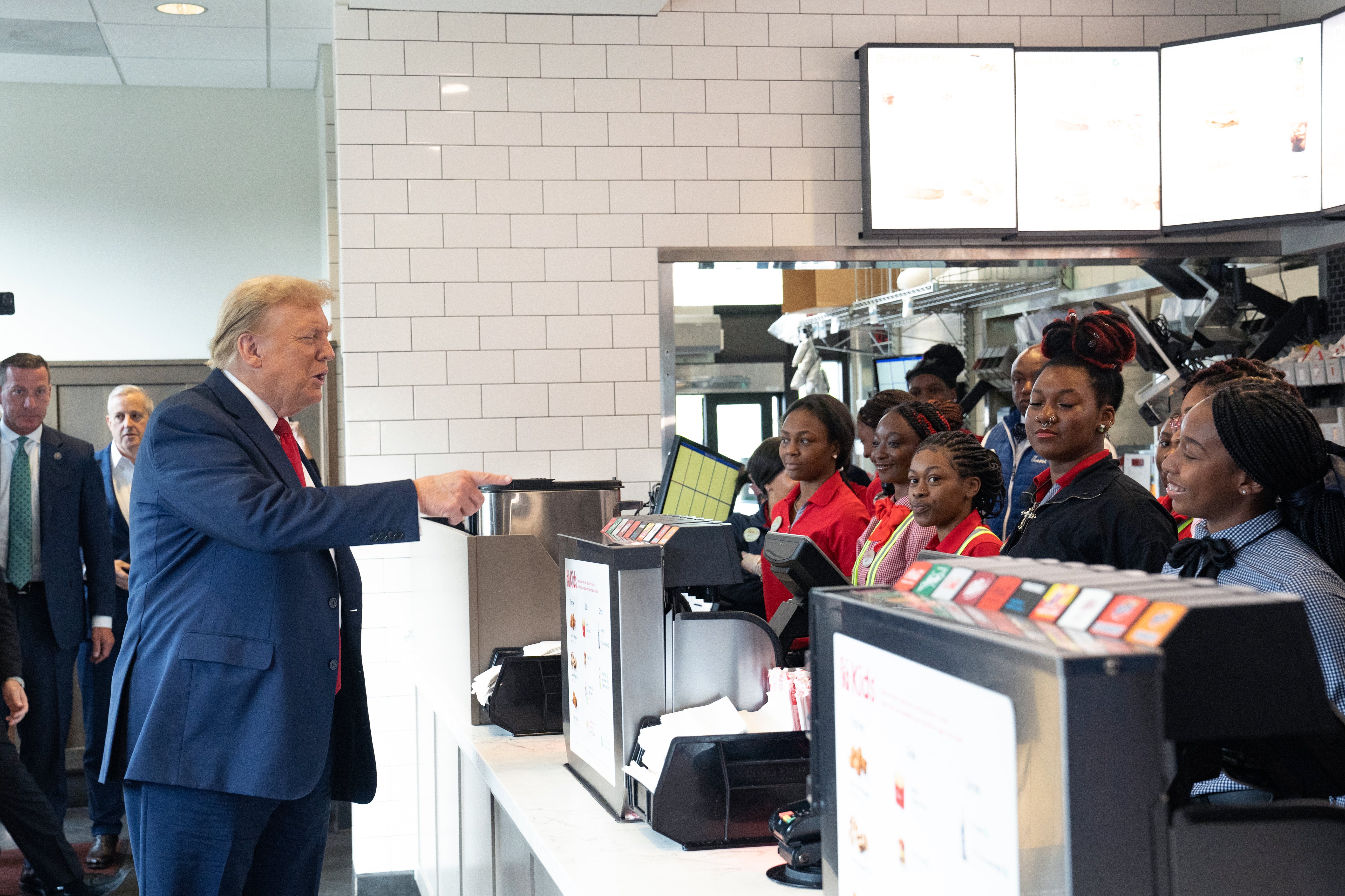 Trump indulges one of his hobbies – handing out fast food - as he hits a Chick-fil-A and buys lunch for fans
