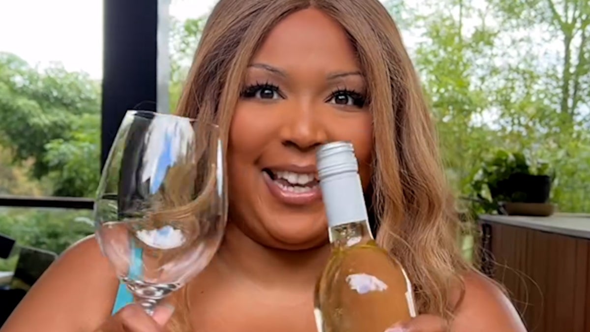 Lizzo swaps weights for wine bottle in satirical weight-loss video