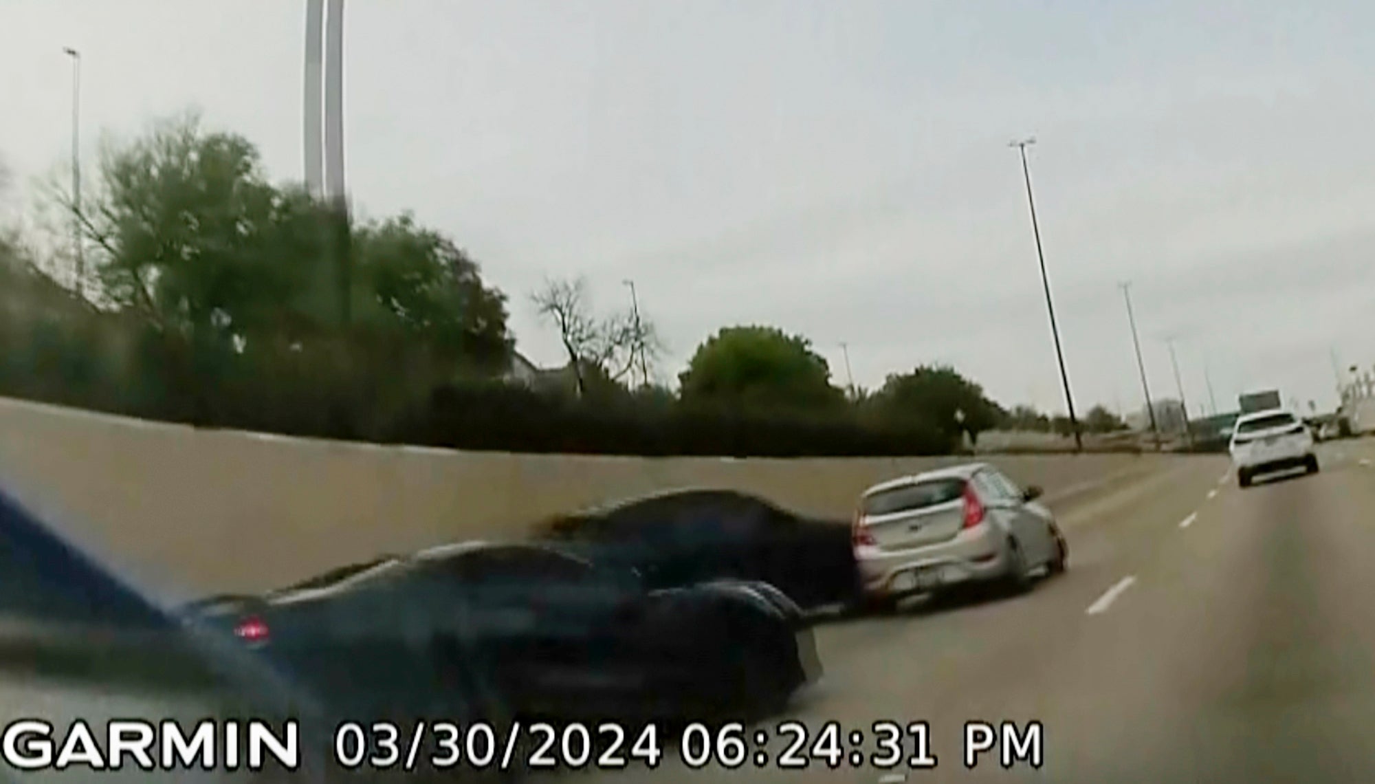 In this screen grab taken from dash camera two speeding sports cars, left and second from left, cause a chain-reaction crash on the North Central Expressway, in Dallas, Saturday, March 30, 2024