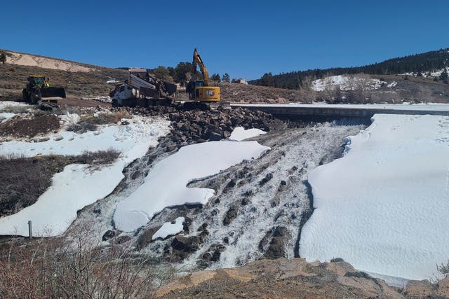 <p>Crews use heavy machinery to place boulders downstream of the cracked Panguitch Lake Dam to reinforce the wall, Wednesday, April 10, 2024, in Panguitch, Utah</p>