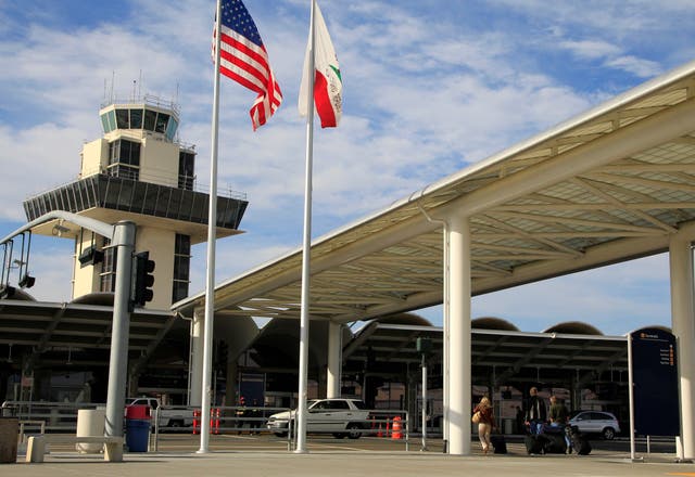 <p>Travelers prepare to enter Oakland International airport</p>
