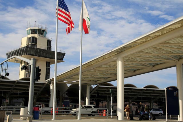 <p>Travelers prepare to enter Oakland International airport</p>