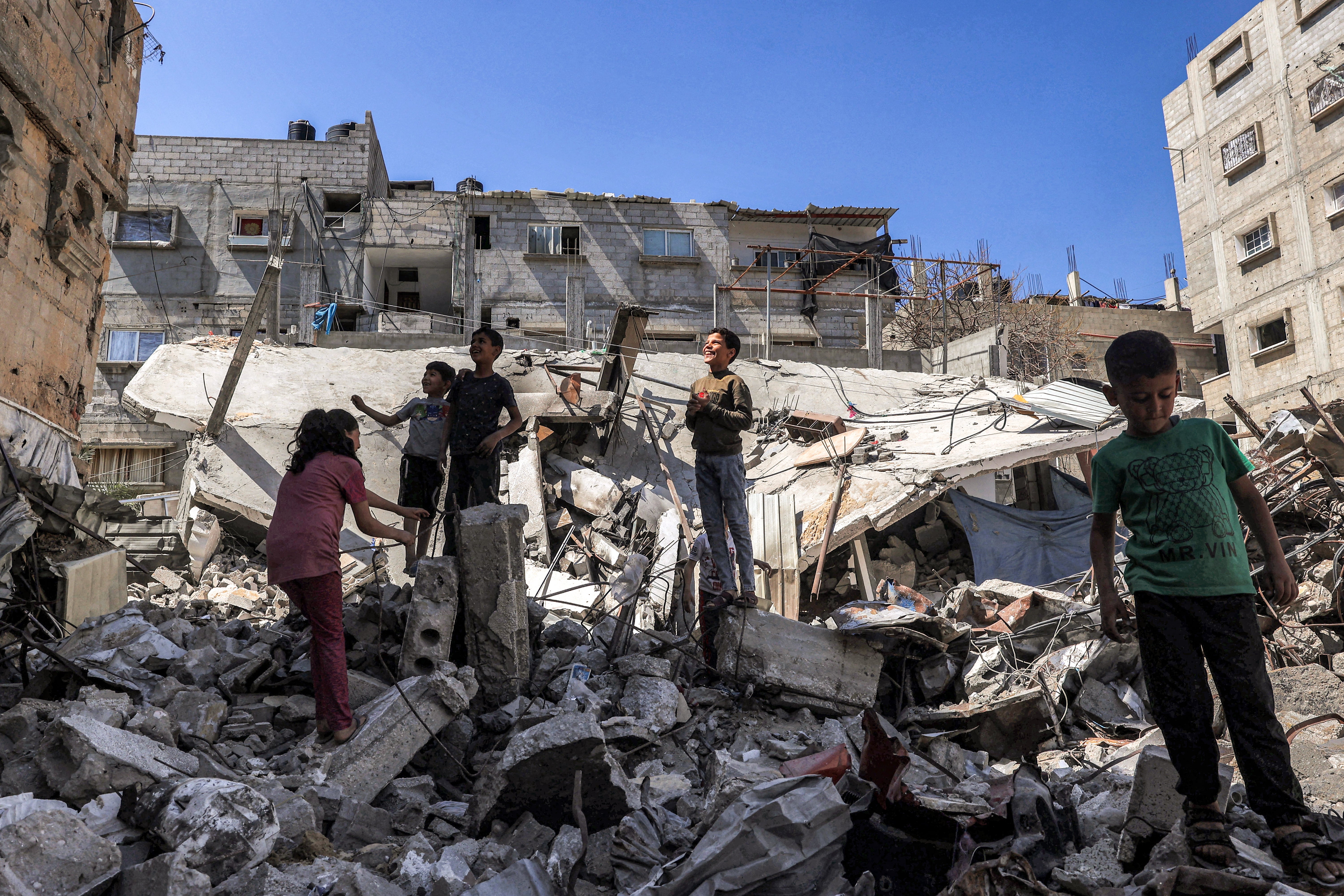 Children stand in the rubble of a collapsed building in Rafah in the southern Gaza Strip