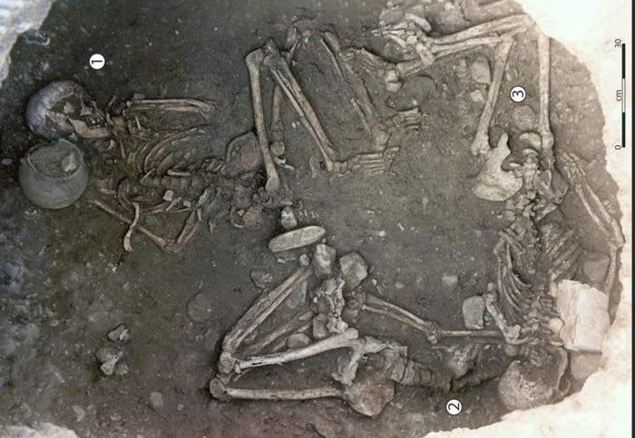 View taken from the upper part of the 255 storage pit showing the three skeletons, with one individual in a central position (Woman 256 1) and the other two placed under the overhang of the wall (Woman 2 and Woman 3)