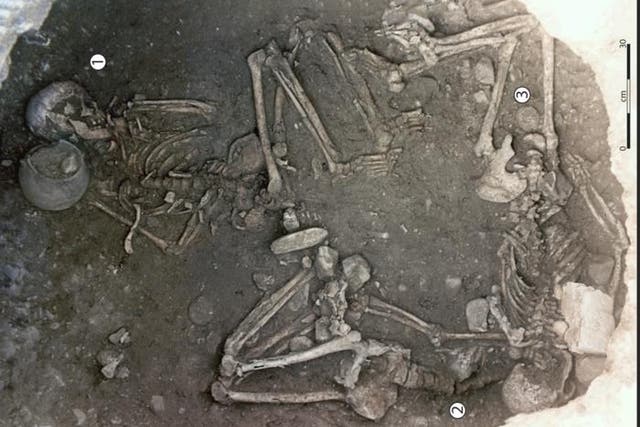 <p>View taken from the upper part of the 255 storage pit showing the three skeletons, with one individual in a central position (Woman 256 1) and the other two placed under the overhang of the wall (Woman 2 and Woman 3)</p>