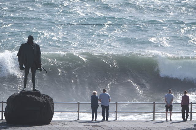 <p>Onlookers watch the high waves breaking at Candelaria, Tenerife</p>