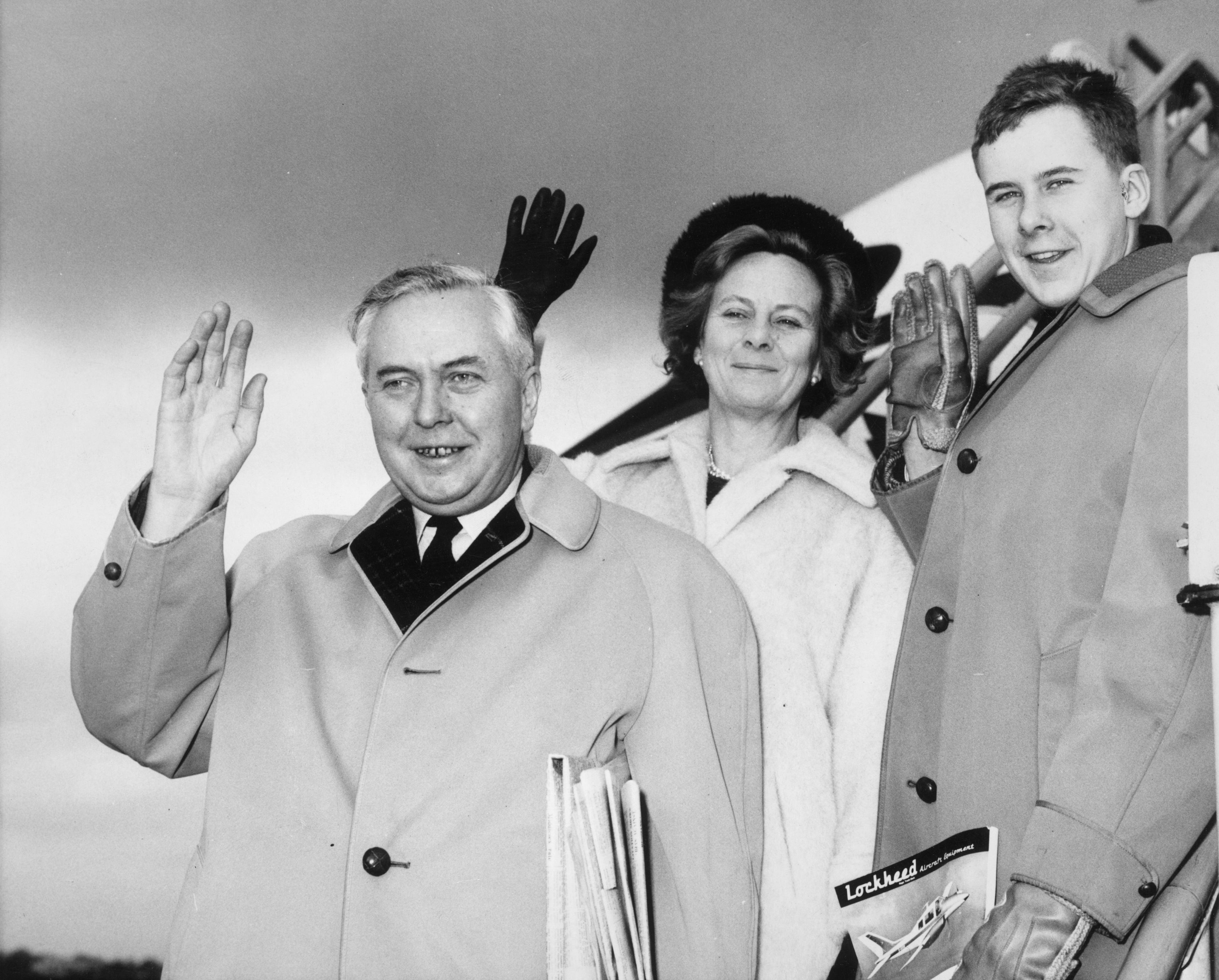 The couple with their son, Robin, next to a private jet