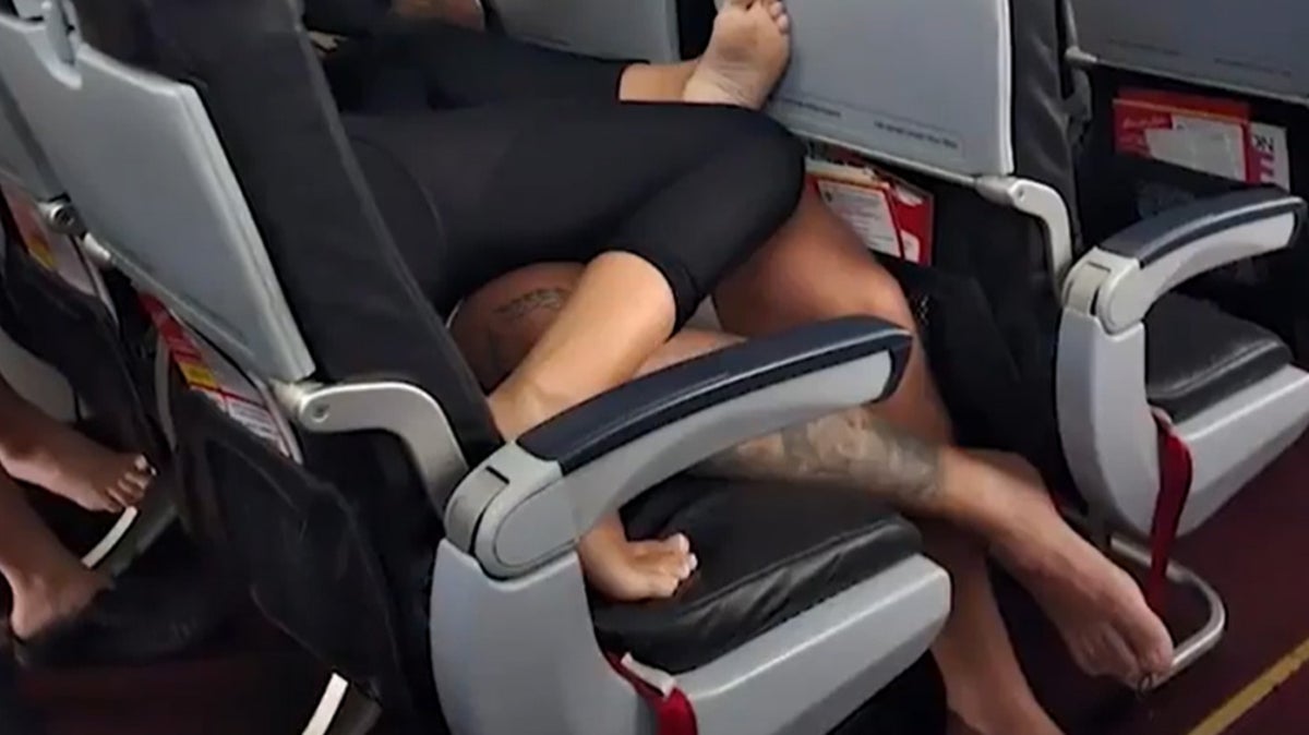 Barefoot plane passengers lying on top of each other mid-flight horrify onlookers