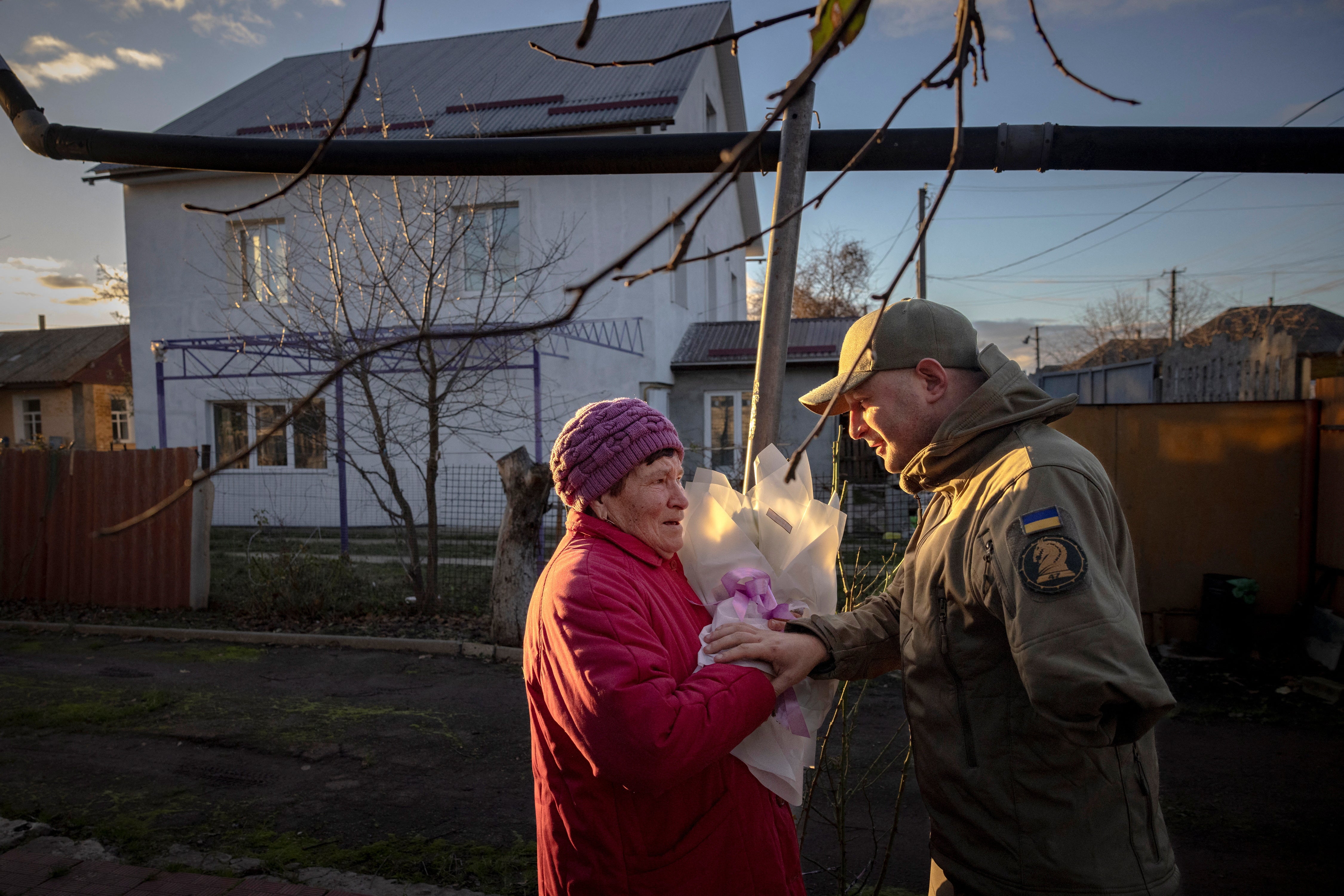 Oleksandr Revtiukh, 33, a Ukrainian serviceman who lost his left arm and most of his left leg in multiple mine blasts in 2023, greets his grandmother in his hometown during his first visit after his injury