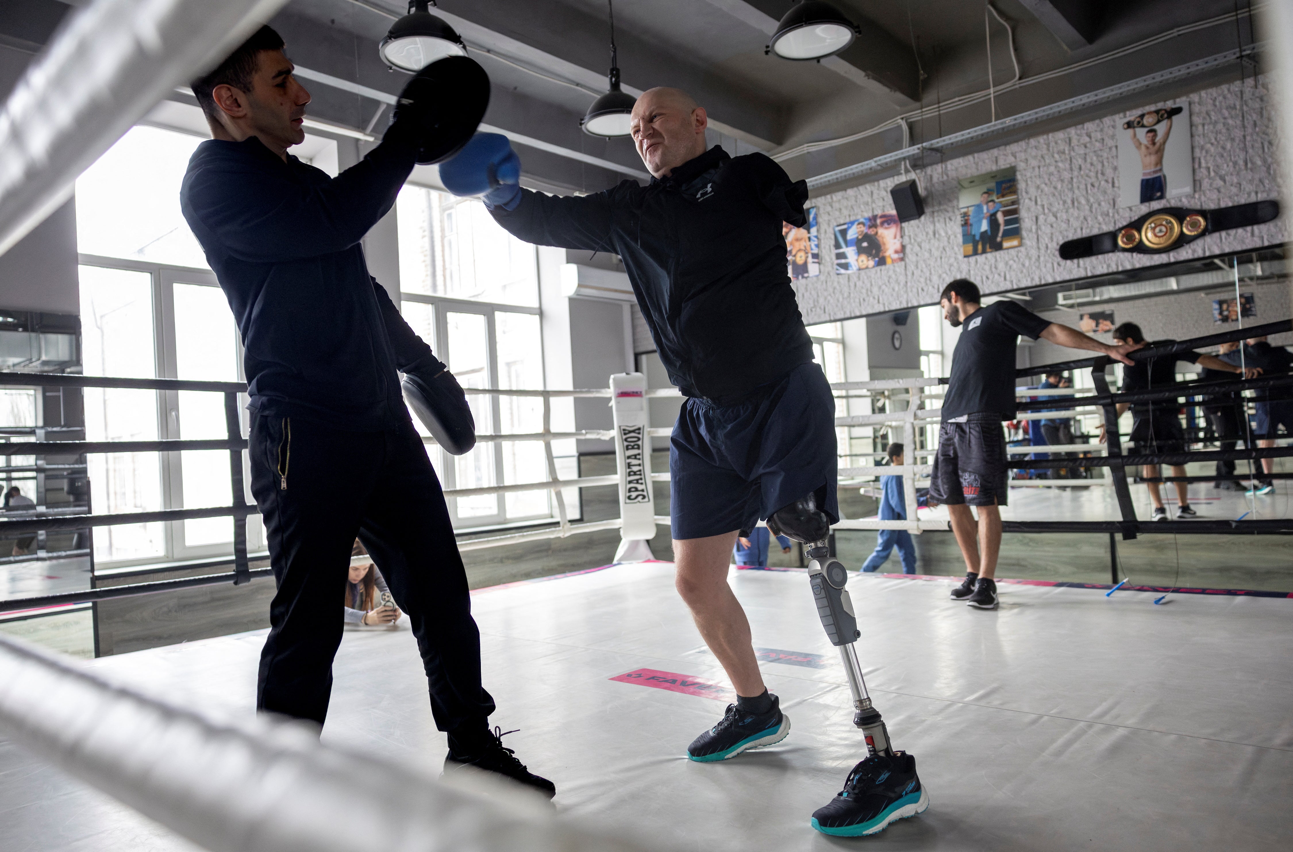 Oleksandr Revtiukh, 33, a Ukrainian serviceman who lost his left arm and most of his left leg in multiple mine blasts in 2023, boxes during a training session at a gym, amid Russia's attack on Ukraine, in Kyiv, Ukraine February 11, 2024