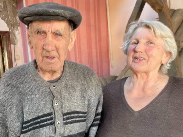 Alexei and Lida amid the ruins of their house