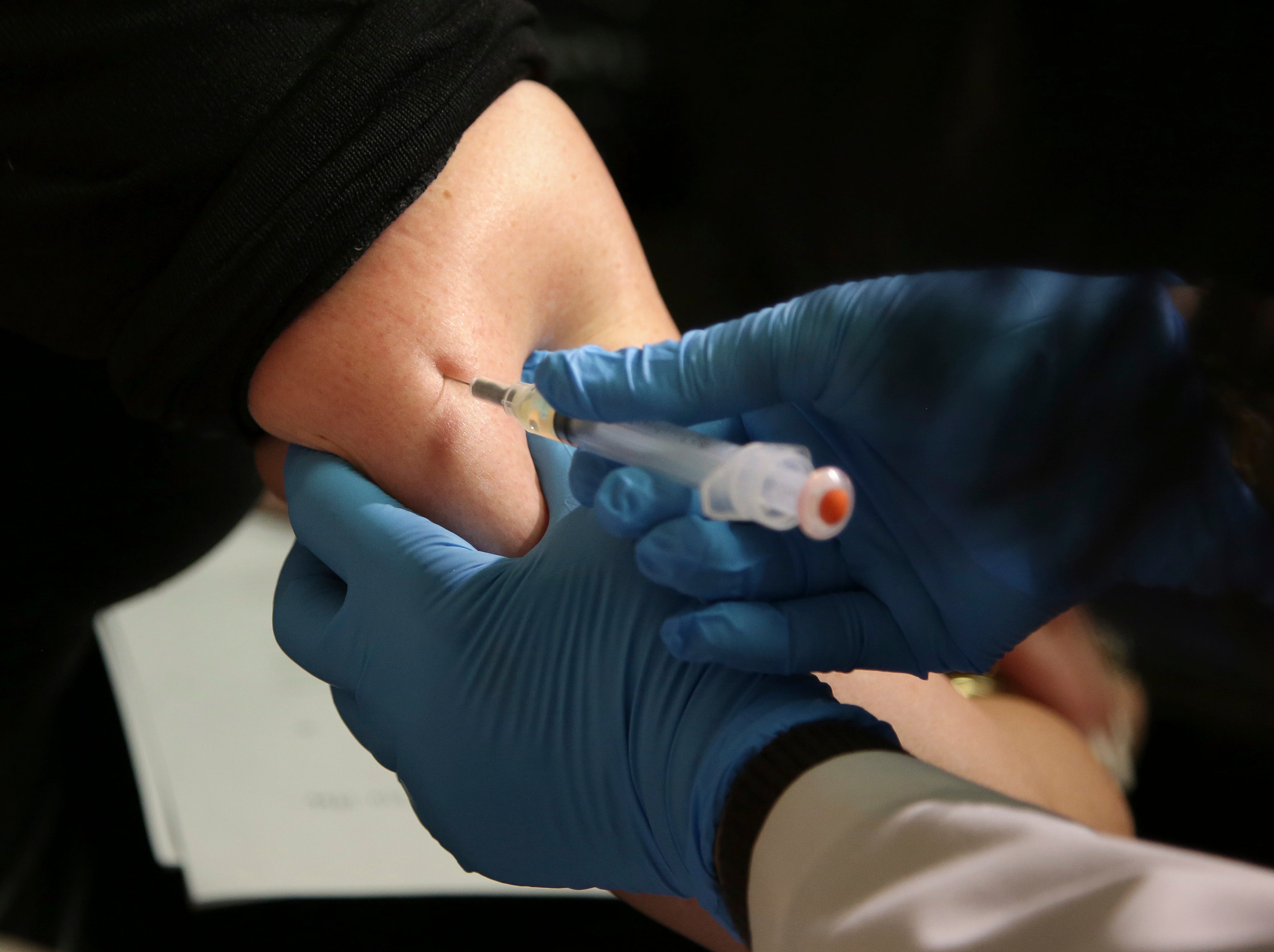 A woman receives a measles, mumps and rubella vaccine at the Rockland County Health Department in Pomona