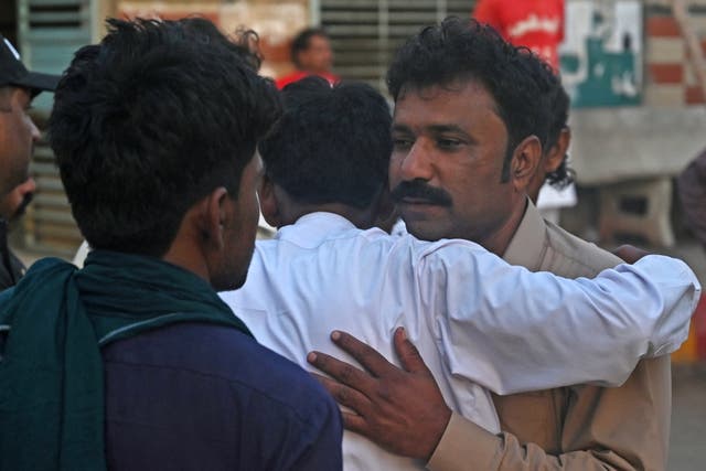 <p>Relatives of religious pilgrims, who died in a truck accident, mourn in Karachi </p>