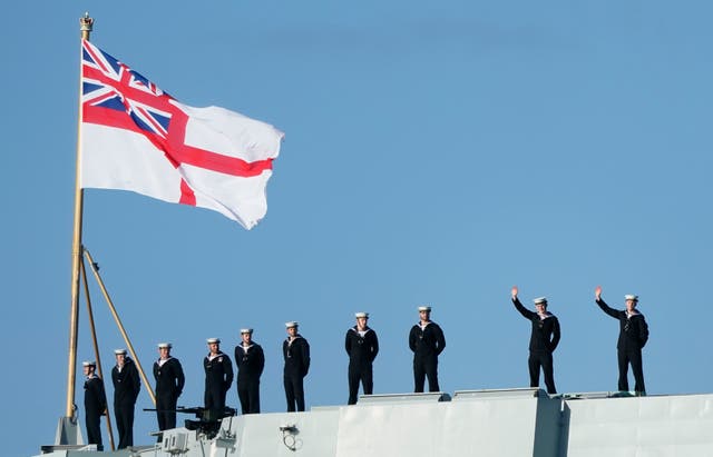 <p>Sailors wave from the stern of the Royal Navy aircraft carrier HMS Prince of Wales as it returns to Portsmouth Naval Base following a three-month deployment to the Eastern Seaboard of the United States</p>