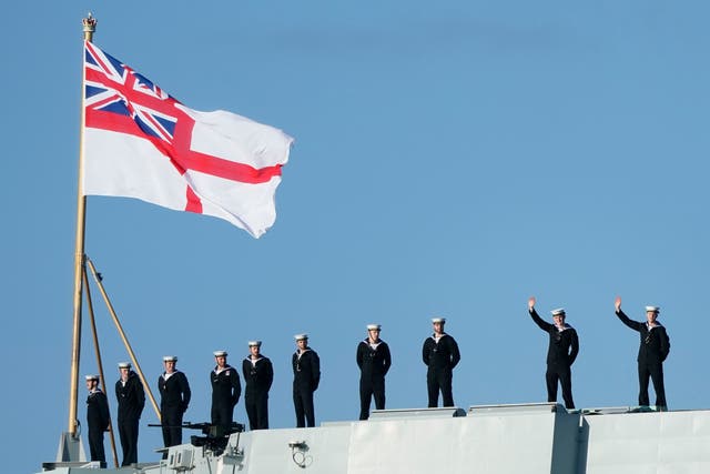 <p>Sailors wave from the stern of the Royal Navy aircraft carrier HMS Prince of Wales as it returns to Portsmouth Naval Base following a three-month deployment to the Eastern Seaboard of the United States</p>