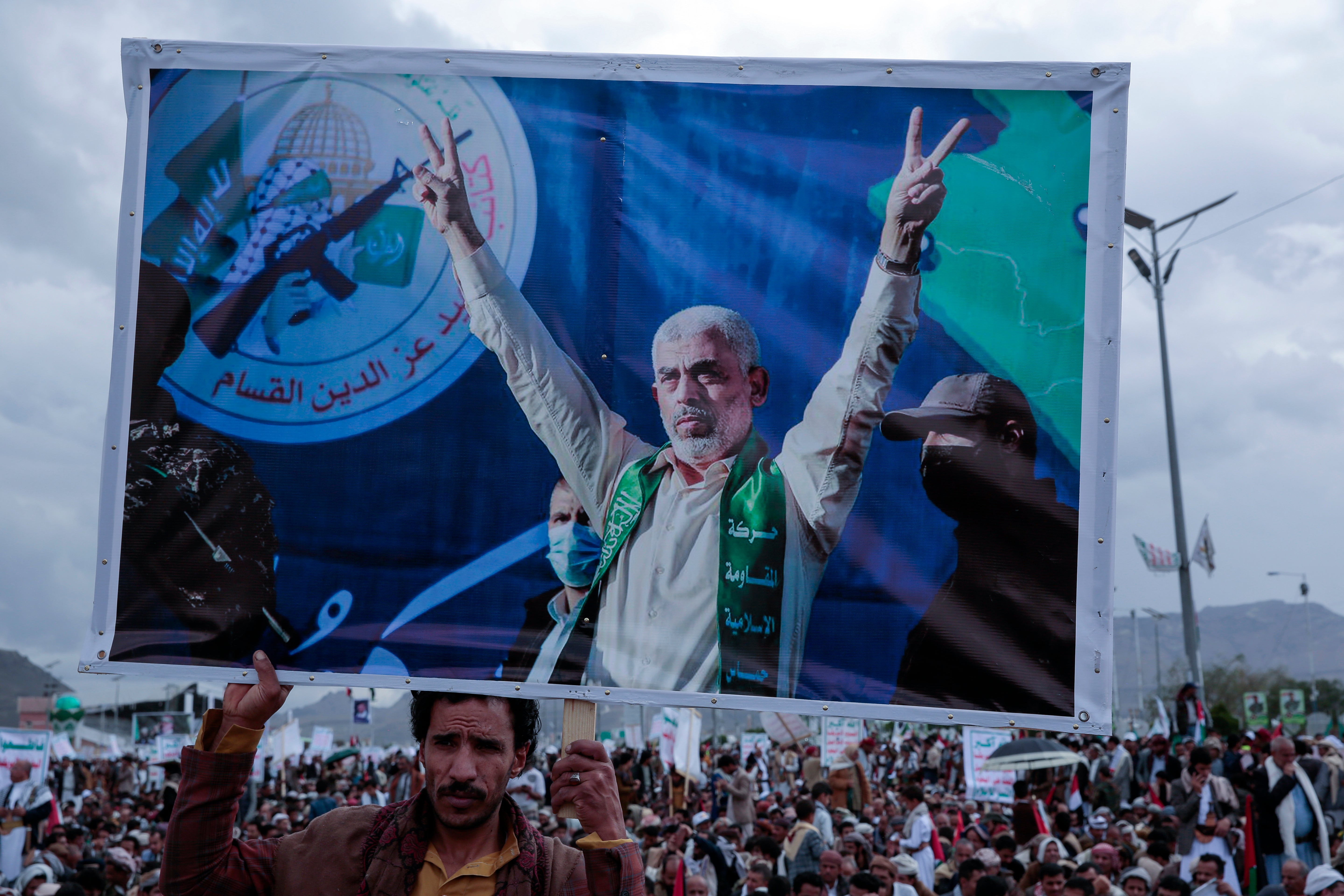 A Houthi supporter holds a poster of Yahya Sinwar, head of the Palestinian Islamic movement Hamas