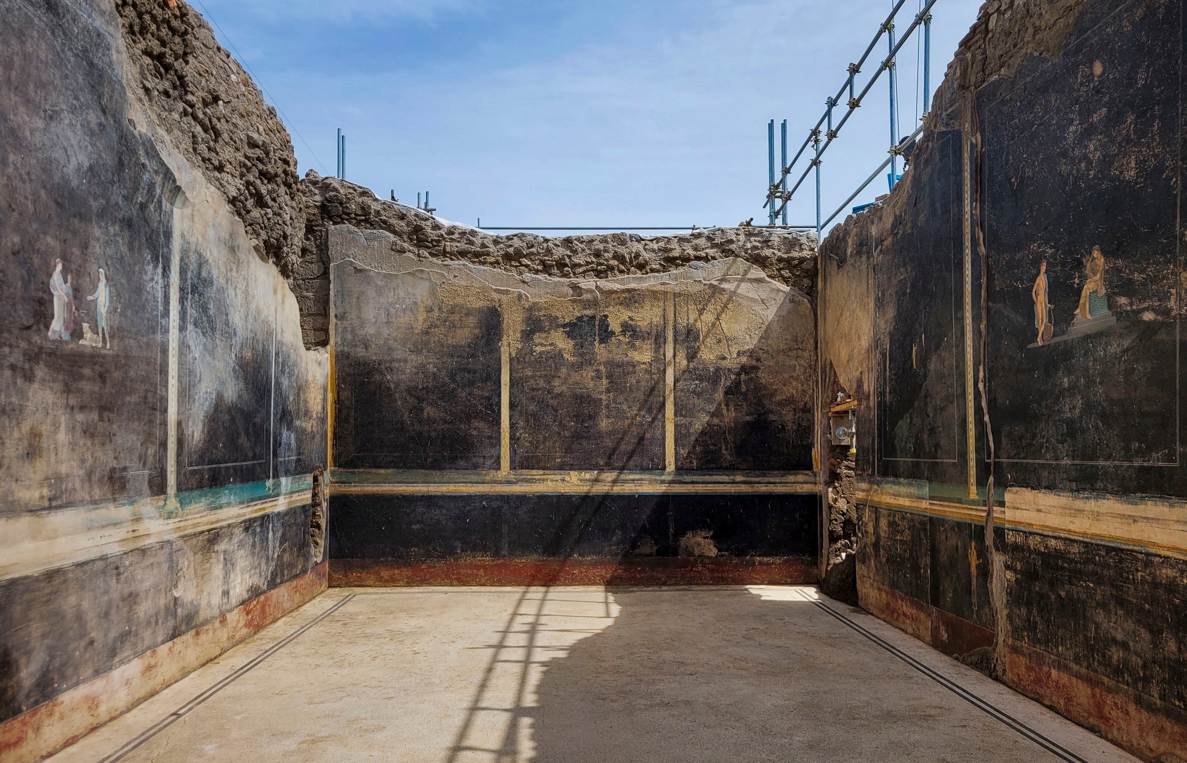 A a banquet hall, with elegant black walls, decorated with mythological subjects inspired by the Trojan War, recently unhearted in the Pompeii archaeological area near Naples in southern Italy