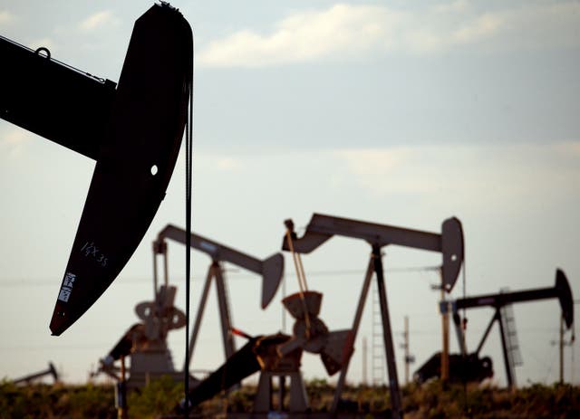 <p>Pump jacks work in a field near Lovington. A carbon tax on oil and gas companies could raise billions, new report says</p>