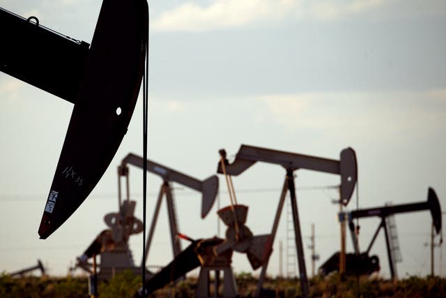 <p>Pump jacks work in a field near Lovington. A carbon tax on oil and gas companies could raise billions, new report says</p>