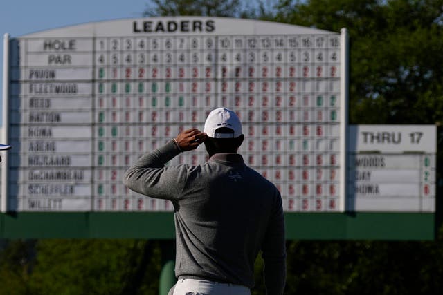 Tiger Woods looks at the leader board on the 18th hole as he eyes a sixth Masters title (George Walker IV/AP)