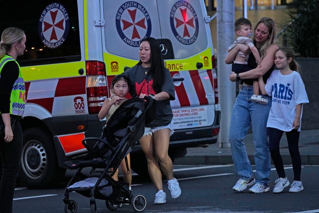 People are led out from the Westfield Shopping Centre (AP Photo/Rick Rycroft)